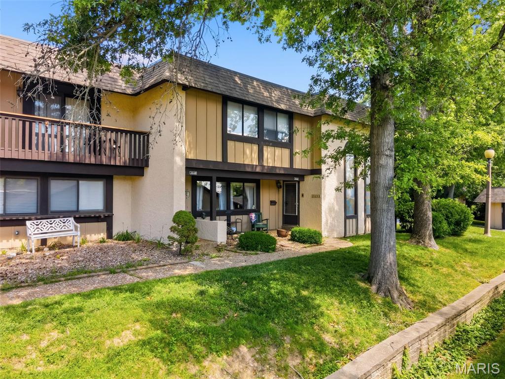 Dynamic townhome in Heritage with approximately 2,301 sq ft of finished living space!  This spacious home offers a fantastic twist on the traditional and expected townhome design.  There is a private patio with planting beds inside the HOA maintained privacy fencing, an oversized 2 car garage (23ft 8 inches D x 21 ft 5 inches W) and a dramatic 2 story Great Room with beamed ceiling and palladium windows.  The patio connects the townhome to the rear entry garage.  Features include an eat in Kitchen with a bay window, solid surface countertops, electric stove, microwave, dishwasher, refrigerator, tile backsplash, Hearth Room, Andersen sliding door, main floor bathroom, main floor laundry closet, Dining Room, large Great Room with floor to ceiling windows, woodburning fireplace, a Loft, spacious Primary Bedroom, walk in closet (2 closets in the Primary), level door hardware, 50 gallon water heater, humidifier, garage door opener and more.  The finished lower level has a Recreation/Family Room, cedar closet, half bath and ample unfinished storage.  The oversized garage is accessible through the courtyard/patio.  The HVAC and humidifier are newer (2022).  The monthly fee covers an extensive list including snow removal, lawn maintenance, landscaping (excluding personal plant areas), some insurance, some exterior maintenance, fencing at courtyard/patio, siding, roof, gutters, downspouts, trash and more.  Take note that there is not an annual fee in addition to the monthly fee.  Mail is delivered directly to the home.  The kitchen refrigerator and lower level freezer are included in the sale.  This home is conveniently located near Highways 94/364, The Centennial Greenway, The Katy Trail, Historic Downtown St. Charles and the popular Streets of St. Charles Entertainment District.  Lambert International is an easy commute.  Uniquely different in the best way, check it out!