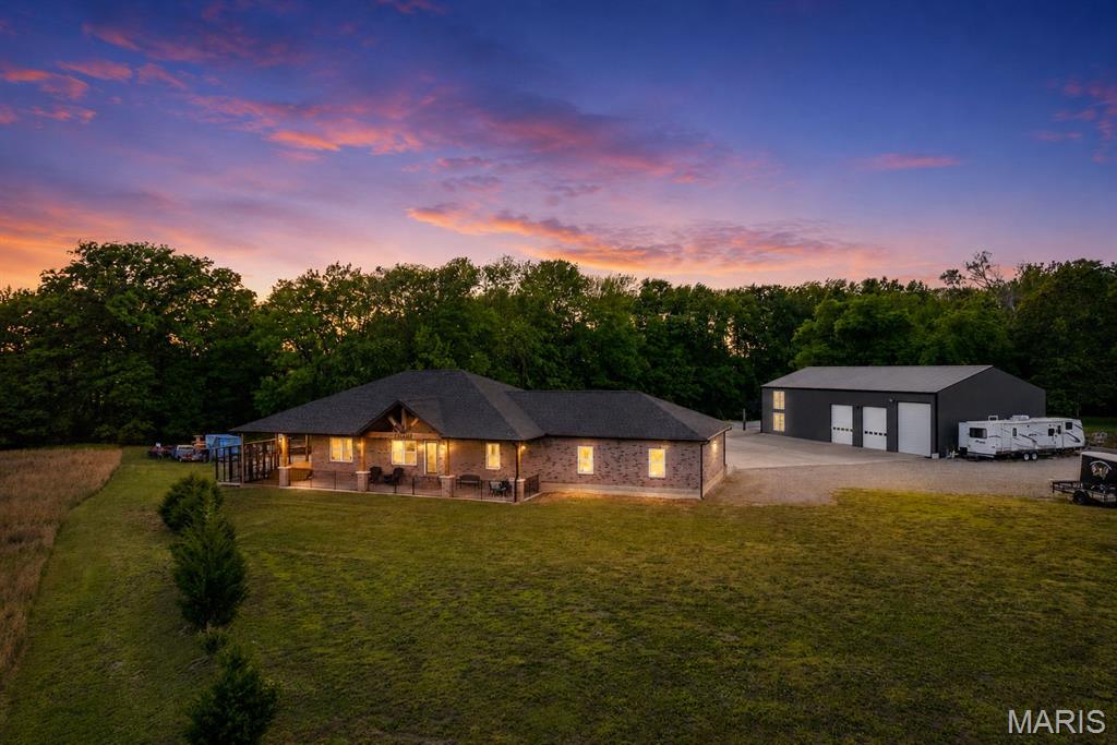 Stunning 3-year-old, all brick home on 5 acres with heated shop and apartment. Discover the perfect
blend of luxury, space and functionality in this beautifully built 1620 sq. ft. all brick home, ideally located
just 2 miles from Gordonville on highway 25. Set on 5 scenic acres, this property is packed with high-end
features inside and out.
The main level oUers 3 bedrooms, 2 ½ baths, quality hardwood and ceramic tile flooring throughout, and
a thoughtfully designed kitchen highlighting custom S&W Knotty Alder cabinetry, granite countertops with
diamond glass backsplash, and a striking leather granite island. An upgraded gas range and stainless-
steel appliances complete the space.
The primary suite features a custom 4’X6’ walk in tiled shower with body sprays, rain head, handheld
shower, plus walk in closet. All bathrooms include custom mirrors with fog settings, and the hall bath
oUers a relaxing jacuzzi tub with blue tooth speaker.
Additional living space includes an 11’X14.5’ oUice or sleeping room in the basement, rough plumbed for
a future fourth bath, and an impressive 30’X44’ basement garage with tesla charger and welder plug in.
The 30’X30’ attached garage is fully finished and Tesla chargers and welding plug in are installed for
modern convenience, also four separates 20 am plug ins for garage refrigerator or deep freezes.
The property truly shines with its 3200 sq ft. heated, three-bay shop, built with 2X6 insulated walls, spray
foam ceiling insulation, and HAVCO boards along side walls. Doors included one 14’X12’ door and two
12’X10’ doors, oUering plenty of room for equipment or vehicles. The shop is fully wired with outlets of 8
ft and includes two dedicated 20-amp circuits for band or specialty use, including multiple welding plugs,
a tesla charger and prewired for two post car lift.
Above the shop is an 800 sq ft heated and cooled apartment with two bedrooms, one bath, and a storage
room ideal for guests or additional income.
There is also an 800 sq ft heated and cooled bar/kitchen area featuring a stunning 20’ custom wood bar,
plus a separate bath and utility room. Outside the bar is a 20’X40’ covered seating area.
Additional features include.
Solar Power, propane gas heat, septic system, county water, SEMO fiber internet, 50 Amp RV plug in
No Covenants or restrictions
This one-of-a-kind property oUers exceptional versatility perfect for homeowners, hobbyists, private
venue, or business owners looking for space, comfort, and quality construction.  Duplicate listing of MLS #26027797.