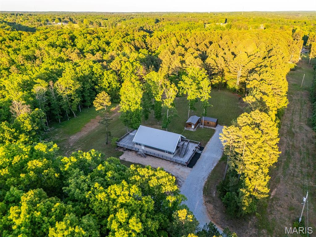 Discover a rare opportunity to own your own slice of paradise near the lovely Big Piney
River in the Houston, MO area. Featuring a charming 3-bedroom, 3-bath home on 10
private acres, this one-and-a-half-story home offers warm, inviting character throughout,
with natural wood finishes and an updated kitchen complete with stainless steel
appliances. Upstairs features a loft overlooking the family room, perfect for an office or a
hang out space, as well as a separate princess suite with an attached full bathroom,
perfect for visiting guests. Outside, a scenic pond provides a peaceful place to fish or
watch the deer and other visiting wildlife, and trails throughout make it easy to enjoy
every acre. Whether you’re looking for a full-time residence, or a weekend getaway to
unplug and get back to the simple enjoyments of life, this property delivers exceptional
versatility. Its proximity to the Big Piney River opens the door to floating, fishing, and
endless outdoor recreation. For those who would like more acreage, up to 61.92 acres
of additional acreage is available. Don’t miss out – call today for your private tour!