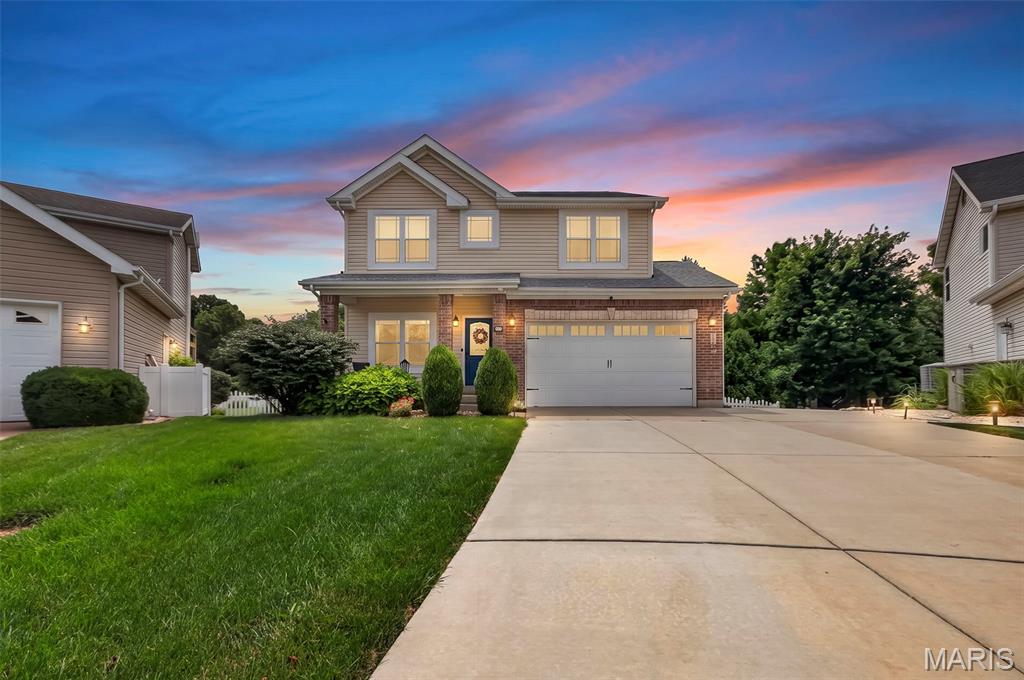 Welcome home to this beautifully maintained 4-bedroom, 3.5-bath two-story home located in the highly sought-after Fort Zumwalt North School District! This spacious home offers an inviting floor plan designed for both everyday living and entertaining. The heart of the home features a warm and welcoming hearth room with a cozy wood-burning fireplace, while the elegant dining room showcases beautiful views, creating the perfect setting for family gatherings and special occasions. The kitchen offers a breakfast bar, stylish tile backsplash, and convenient main-floor laundry just steps away. Retreat to the spacious primary suite featuring a coffered ceiling, walk-in closet, double vanity, relaxing garden tub, and separate shower. Three additional bedrooms provide plenty of space for family or guests. The finished lower level expands your living space with a large recreation room, dedicated office, and utility/storage room, making it ideal for work, play, or hobbies. Step outside to enjoy the oversized deck overlooking the fully vinyl-fenced backyard, perfect for entertaining, pets, or play. Additional storage beneath the deck provides room for outdoor equipment and seasonal items. Enjoy a fully covered 2nd deck at ground level with a waterproof ceiling. Conveniently located in O'Fallon near parks, shopping, dining, and major commuter routes, this move-in ready home offers the perfect combination of comfort, functionality, and location.
