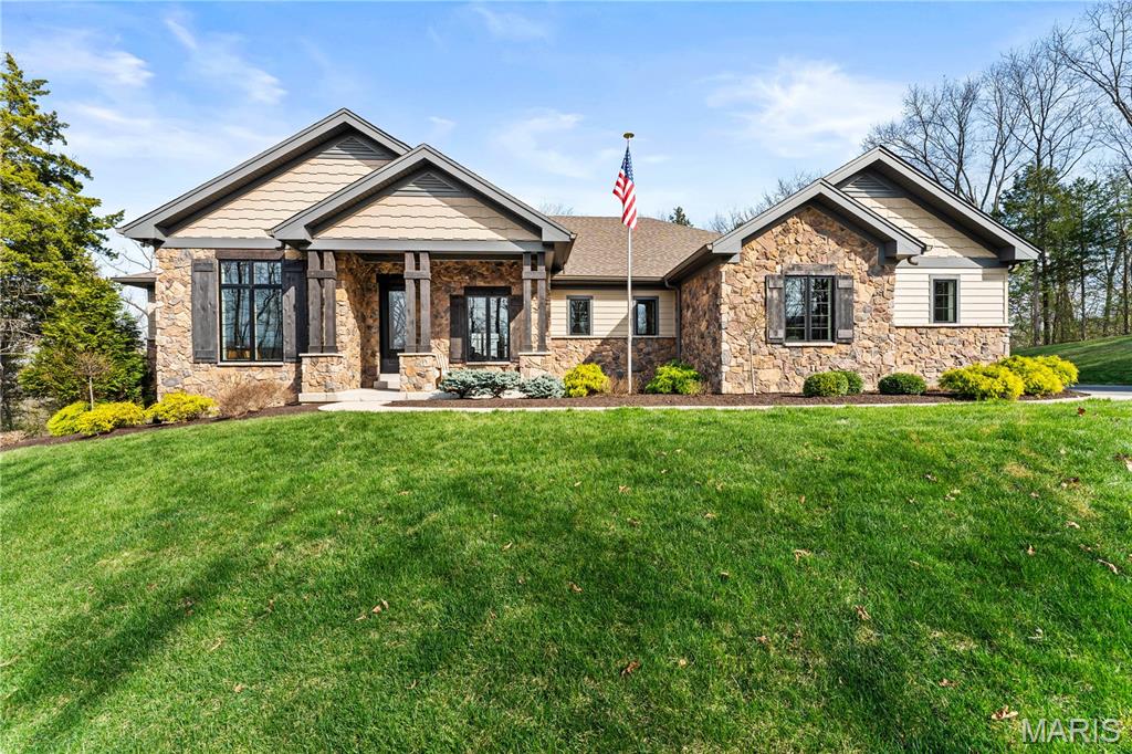 A secluded retreat centered around wellness, comfort, and relaxation. Set on three private acres, this property’s hallmark feature is a custom saltwater pool with an infinity edge that can be both heated and chilled. Gorgeous hardwood floors and fine moldings throughout the main living areas make this home a designer showcase. The main level features an open layout where the kitchen, dining, and great room with gas fireplace connect seamlessly, framed by large windows overlooking the wooded backdrop. The kitchen offers a generous island, professional-grade appliances, custom cabinetry, large bar, walk-in pantry with Costco door and quartz counters. The primary suite is a private retreat with dual walk-in closets, a spa-like bath with a soaking tub, a multi-head shower, a Toto smart toilet, and access to a covered deck. An additional bedroom suite, laundry room, and an office complete the main level. The walk-out lower level has two additional bedrooms, a full bath, and a recreation room with a wet bar. The spa-like feel continues with a well-appointed exercise room including an infrared sauna. This is a complete smart home operated by your phone to simplify everyday living. The three-car garage includes a Tesla charger. Upgraded insulation and energy-efficient systems. In-ceiling speakers throughout the home and deck, a whole-house 24 kW generator, and irrigation system make this an ideal property.
