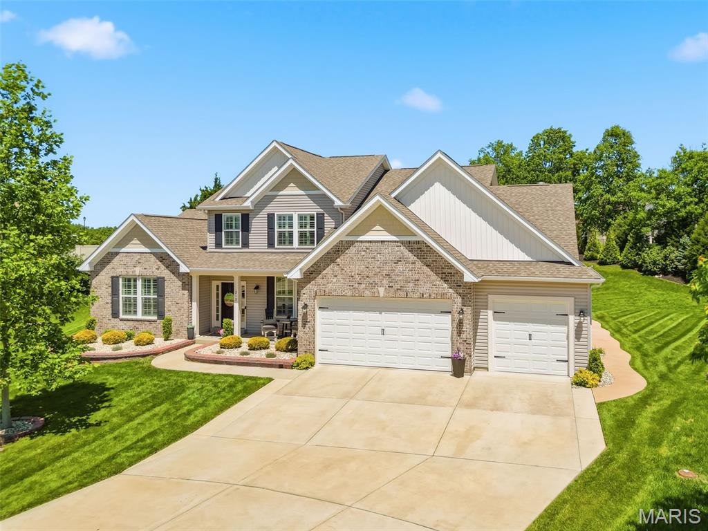Experience refined living in the stunning 4-bedroom, 3.5-bath, 1.5 story home, perfectly situated in Lake St. Louis. Every inch of the home has been thoughtfully updated, blending elegance, functionality and luxury, all situated on a cul-de-sac in the Wentzville-Timberland school district. Sitting on 0.4 of an acre, the spacious backyard, large patio and beautiful landscaping provide an excellent space to play and entertain. The gourmet kitchen is the centerpiece of the home, with granite counter tops, breakfast bar, custom cabinets, contemporary lighting and high end stainless steel appliances with double oven, gas range and refrigerator (included). The hearth room w/ gas fireplace, breakfast room, living room and formal dining room provide an open concept feel with beautiful hardwood flooring and natural light. The main floor primary bedroom suite features a coffered ceiling, plantation shutters, a large walk-in closet with custom shelving and a beautiful primary bathroom w/ dual vanities, soaking tub and separate shower. Upstairs you will find a large loft area and 3 spacious bedrooms, one w/ an ensuite bathroom and two others share a jack-and-jill bathroom, all with custom walk-in closets. Additional features include dual water heaters, zoned HVAC system, 9 ft basement foundation, irrigation system and expanded 3-car garage (32x23) w/ side service door. If you've been dreaming of modern updates that deliver both grander and warmth, this property delivers unmatched quality and comfort that you will enjoy for years to come!