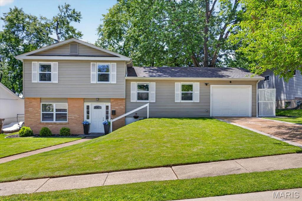 Beautifully updated multi-level home with excellent curb appeal offers 3 bedrooms, 1.5 bathrooms, and over 1,400 sq ft of living space. This move-in ready home blends thoughtful stylish updates designed for today’s lifestyle. Step inside to the welcoming foyer to find neutral paint colors and an open, inviting floor plan. The spacious kitchen and dining area feature hardwood floors, granite countertops, center island, stainless steel appliances, and abundant cabinetry — ideal for everyday living and entertaining alike. The cozy family room offers sliding glass door access to the expansive rear patio with gazebo, an oversized fully fenced backyard with mature trees, and plenty of room to relax or play outdoors. The upper level includes a primary bedroom with double closets, two additional nice-sized bedrooms, and an updated full hall bathroom. The basement offers flexible space perfect for a home office or workout room, plus laundry and plenty of storage. Additional highlights include an updated half bath, mud room, attached one-car garage with opener (2017), roof (2017), windows (2017), electrical panel (2017), and HVAC (2023). Fantastic location in Westhaven subdivision near Westport Plaza, restaurants, shopping, parks, and schools, with convenient access to Highways 70 and 270 for an easy commute!