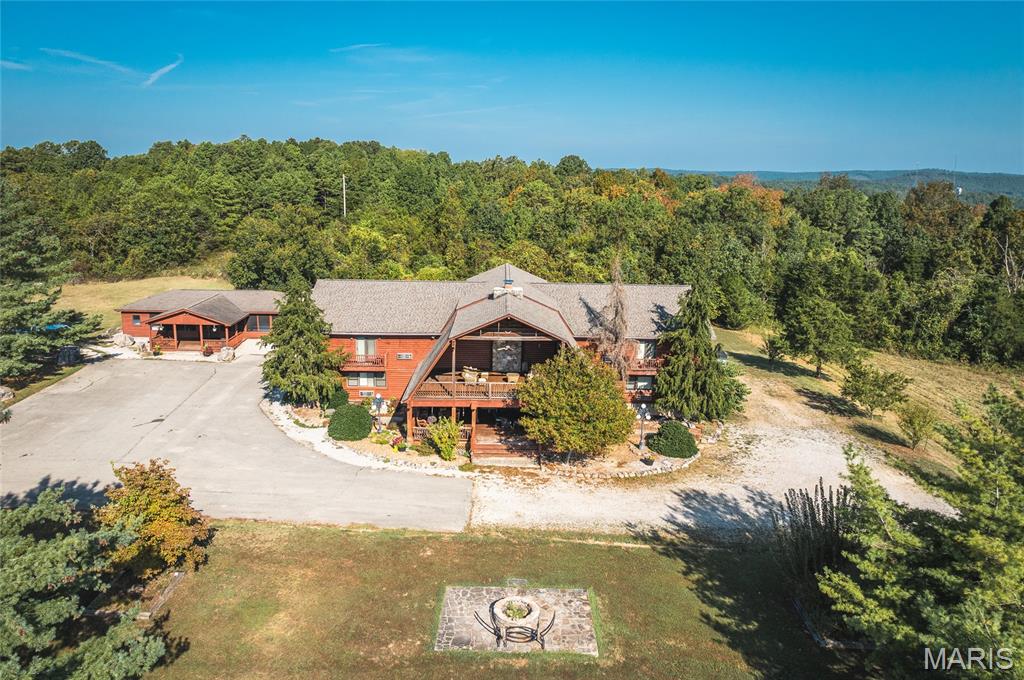 Price listed is Starting Bid Only. Bidding starts closing  07/31/2026 @ 12PM Exceptional investment opportunity to acquire the renowned Cedar Stone Lodge, a premier hospitality and event destination nestled on approximately 26± acres in the heart of Missouri's scenic Ozarks. Ideally located less than one mile from the crystal-clear Jacks Fork River and the Ozark National Scenic Riverways, this income-producing property offers a unique blend of luxury lodging, event hosting potential, and future expansion opportunities. The property is highlighted by an impressive 12,000± square foot log lodge featuring stunning post-and-beam construction, soaring vaulted ceilings, expansive covered decks, a massive stone fireplace, commercial kitchen facilities, and accommodations for up to 42 guests. Designed with rustic elegance and modern comfort in mind, the lodge includes multiple en-suite guest rooms, spacious common areas, and gathering spaces ideal for retreats, reunions, corporate events, weddings, and group gatherings. The lodge is being offered fully furnished, allowing for a seamless transition to new ownership. The resort is further enhanced by four private log cabins and a storage building, with the cabins also selling fully furnished. A covered pavilion provides an exceptional outdoor gathering space and features full electric capabilities, a propane-burning fireplace with a beautiful stone mantle, and a bar area, making it ideal for weddings, receptions, parties, and special events. Guests enjoy a peaceful setting with modern amenities while remaining minutes from floating, fishing, horseback riding, hiking, wildlife viewing, and the famous wild horses of Shannon County. Currently operating as a successful lodging destination, Cedar Stone Lodge offers 11 lodge rooms with private baths along with the private cabins, providing flexibility for individual travelers, family gatherings, church groups, corporate retreats, and special events. Located along Highway 19, with breathtaking Ozark views, established lodging infrastructure, commercial kitchen facilities, event-ready amenities, and a location within one of Missouri's most visited outdoor recreation regions, Cedar Stone Lodge presents a rare opportunity to own a turnkey hospitality and event venue with substantial income-producing potential and room for future growth.
** The 26± acres being conveyed are part of a larger tract, and the property lines depicted are approximate. A new survey will be completed prior to closing to establish the final parcel boundaries **  Property will sell under auction terms and be sold AS- IS, WHERE-IS. Seller, will not make any repairs as a result of any building, occupancy, or environmental inspections. Buyer will be required to sign an Auction Purchase & Sale Agreement if final bid is accepted by Sellers.