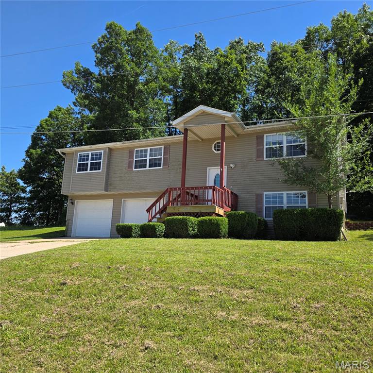 Welcome to this spacious split foyer in the desirable Wyndridge Estates subdivision, located just minutes from Fort Leonard Wood, shopping, dining, schools, and everyday conveniences while still enjoying the benefit of being outside the city limits. Offering approximately 3,400 square feet of living space, this 4-bedroom, 3-bath home provides a functional layout with room to spread out.
The main level features a bright living room, dining area, and kitchen with ample cabinet space, a pantry, breakfast bar, Whirlpool range and microwave, KitchenAid refrigerator, GE dishwasher, and garbage disposal. The finished lower level offers a spacious family room, laundry area, and additional storage beneath the stairs.
The primary suite includes a walk-in closet with attic access, double vanity, and jetted tub/shower combination. All bedrooms feature closets with interior lighting.
Recent updates include a new HVAC system (2025), new roof, GE dishwasher (2025), Whirlpool microwave (2025), and KitchenAid refrigerator (2025). Additional features include public water and sewer, an oversized two-car garage with finished concrete floor, backyard deck, covered front porch, and underground drainage systems at the rear corners of the home to help direct roof runoff away from the foundation.
Situated on approximately 0.40 acres, this home offers generous living space, major system updates, and an excellent opportunity for buyers to personalize and add value while enjoying a convenient location near Fort Leonard Wood. Schedule your private showing today!