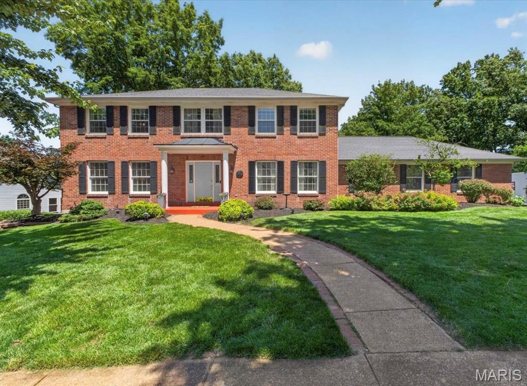 Charming 2-story home set on a large, level lot backing to trees for exceptional privacy and a serene backyard setting. From the moment you enter, you'll appreciate the handsome wood flooring that flows through the formal living room/home office and elegant dining room. The spacious great room is filled with natural light and features a bay window, gas fireplace with stone surround, and custom built-in shelving. The well-appointed kitchen is designed for both everyday living and entertaining, offering granite countertops, a custom tile backsplash, stainless steel appliances, double ovens, a gas cooktop, and an adjoing breakfast room with a planning desk, walk-in pantry and access to a large stamped concrete patio. Upstairs, the spacious primary suite features a walk-in closet and a private ensuite bath with double vanities and a walk-in shower. Three additional bedrooms and an updated full bath complete the upper level. The finished walk-out lower level expands the living space with a large family room, exercise room, additional bedroom, and full bath, ideal for guests, entertaining, or a private retreat. Additional highlights include main-level laundry, an oversized 2-car garage, newer zoned HVAC system (2024), and much more. A wonderful combination of space, updates, and privacy in the highly desirable Rockwood School District!
