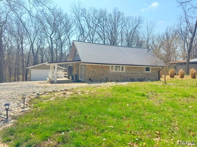 Wow!  Charming stone cottage is gently nestled in the woods and surrounded by beautiful landscaping, offering a peaceful country setting backing to woods. Inside, cathedral ceilings create an open, airy feel, while a loft accessed by ladder serves as a second bedroom or additional sleeping area.  Home boasts spacious living areas,  abundant closet space, tastefully updated kitchen and bathroom, custom lighting/ceiling fans throughout. A 20x22 detached two-car garage adds convenience.   Grayhawk’s amenities include two 100-acre lakes for fishing and boating, a community pool, playground, and a variety of social activities—all within the gated Grayhawk Lake community.
Lovingly maintained and completely renovated over the past 10 years, this home truly reflects pride of ownership.  Back on market, buyer did not perform.