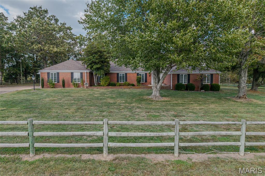 Enjoy peaceful country living just minutes from town! This beautiful ranch-style home sits on 11 secluded acres on the south side of town, featuring a paved driveway and a park-like setting full of wildlife. With over 4,000 sq. ft. of living space, this 5-bedroom, 4.5-bath home offers plenty of room for everyone. Inside you’ll find multiple living areas including a formal living room, family room with fireplace, den, formal dining room, breakfast room, and a large kitchen with tons of cabinets and storage. The spacious master suite features a relaxing master bath with a separate shower and walk-in tub. Step outside to a huge back patio—perfect for entertaining or simply relaxing while you enjoy the peaceful surroundings. Property also includes a 30x40 barn with concrete floors, a large shed/barn for extra storage, and some fencing already in place. The perfect mix of country comfort, privacy, and convenience—just minutes from town!