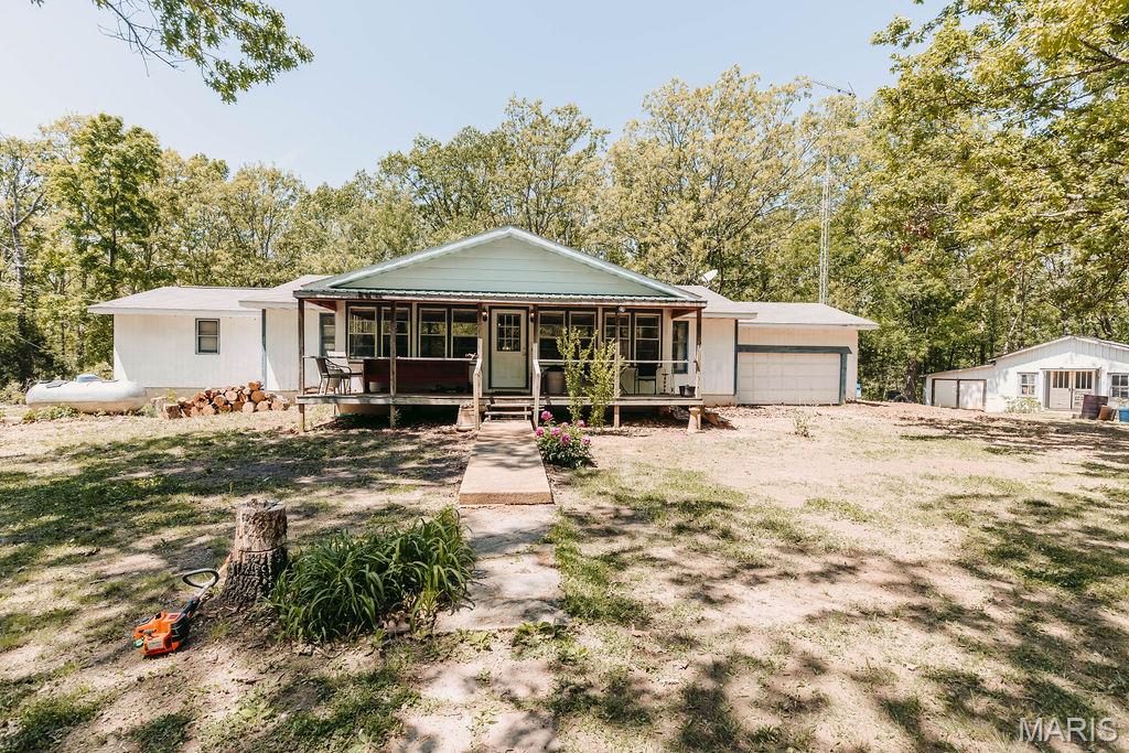Set on 31.6 beautiful acres, this secluded country property offers the perfect blend of privacy, nature, and outdoor living. Surrounded by mature woods and abundant wildlife, the land provides an ideal setting for hunting, recreation, or simply enjoying the peace and quiet of the countryside.

The property features a charming 4-bedroom, 2 bath, 2,334 sq. ft. country home tucked away from the road, creating a private retreat with scenic natural surroundings in every direction. The home is being sold as is and needs a touch of TLC. Two ponds add to the beauty and functionality of the land, offering peaceful water views, fishing opportunities, and attracting wildlife throughout the year.

With multiple outbuildings already in place, there is ample space for equipment storage, workshops, farming needs, or recreational vehicles. Whether you are looking for a hunting property, weekend getaway, homestead, or full-time rural residence, this unique acreage offers endless possibilities for outdoor enthusiasts and those seeking a slower pace of life.

Enjoy the tranquility of nature, wide open spaces, wooded trails, and the rare opportunity to own a private slice of the countryside with room to explore, relax, and create your vision. The property is located 25 minutes to Rolla, St Robert and Ft Leonard Wood East gate. Thousands of acres of National Forest and the Big Piney River just minutes away for additional fun and adventure.
