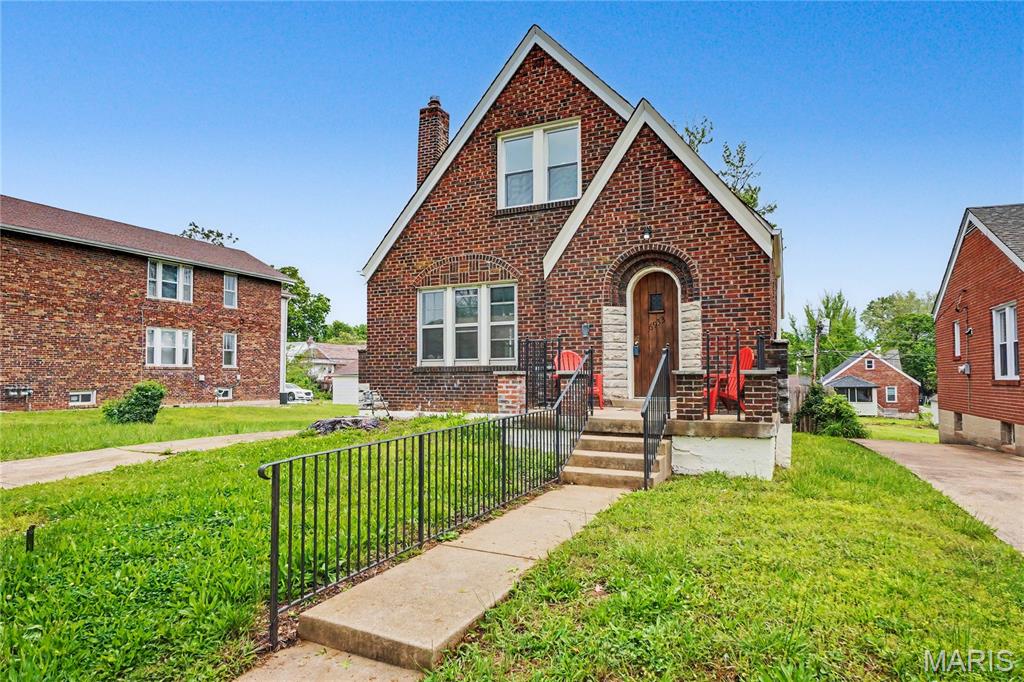 Historic character. Luxury renovation. Deceivingly large space. A rare blend of classic University City charm and modern livability.

Welcome to this beautifully transformed brick bungalow in the heart of University City, where timeless architecture meets thoughtful, fully permitted modern upgrades. Rich in original character yet designed for today’s lifestyle, this home offers the perfect blend of warmth, sophistication, and functionality.

From the moment you arrive, the home makes an unforgettable first impression with its storybook arched stone-and-brick entryway, warm wood front door, and striking masonry detail—an architectural feature that immediately sets it apart. Inside, graceful arched interior openings, recently refinished hardwood floors, and a beautiful new fireplace create a welcoming atmosphere filled with charm and elevated design.

As you enter, the spacious living room is power-packed with original character, such as the original windows that flank the new fireplace, large front windows that allow so much natural light, original wood floors, and arched entryway into the dining room.

The elegantly understated formal dining room is large enough for a table seating up to 12! Continuing back from the dining room, you can enter the hallway to the 2 main-level bedrooms and bathroom or enter the kitchen. The kitchen is completely redesigned, for both everyday living and entertaining, the kitchen showcases stylish finishes, generous prep space, new appliances, and a seamless connection to the home’s dining and living areas, bringing together timeless character and modern livability. The main-level bedroom at the rear of the home has ample natural light and is generously-sized. The other main-level bedroom has a custom, built-in bookcase that makes storage a breeze!

The renovations continue upstairs with fully permitted improvements that dramatically expand the home’s functionality, including a private upper-level primary suite featuring a spacious bedroom retreat and beautifully appointed full bath and a right-sized walk-in-closet—creating the kind of owner’s sanctuary buyers crave. The other upper-level bedroom is also generously-sized and overlooks the back yard.

The walk-out lower level has also been enhanced with an added full bathroom, large family room, and a large bonus room! The bonus room could easily be useful for a media room, exercise room, large home office, or a 5th sleeping area.

Step outside and discover an outdoor setting that is just as compelling. A covered rear deck crafted in warm natural wood tones creates the perfect place for morning coffee, outdoor dining, or evening entertaining, all overlooking an expansive fully fenced backyard on your double lot—a rare amenity offering privacy, play space, gardening potential, and room to truly enjoy outdoor living.

Ideally located near the exciting continued investment and revitalization along Page Avenue and just minutes from shopping, dining, parks, and entertainment throughout University City, Clayton, and St. Louis; this home offers a lifestyle that is as convenient as it is charming.

Architectural character. Luxury updates. Modern floorplan. Exceptional outdoor space.
This is University City living at its finest.