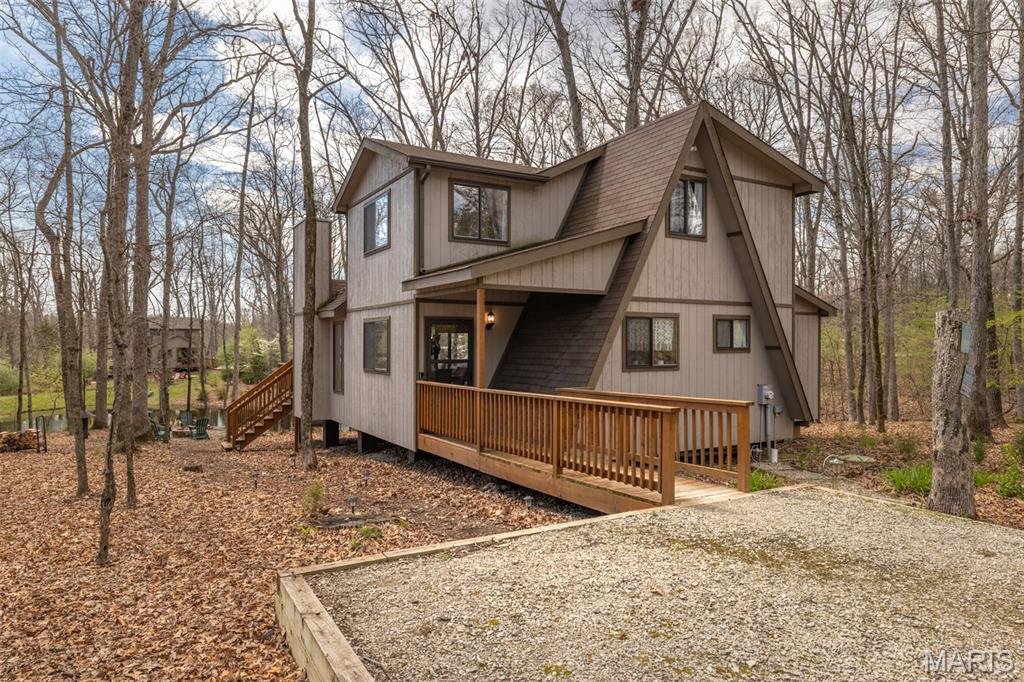 Welcome to this picturesque 2 bedroom, 2 bathrooms Chalet on Turrach lake, offering a park like setting with accessible water access. Inside, you'll be greeted by expansive floor to ceiling windows, a stone fireplace, and a variety of T&G cedar covering the walls and ceilings. The oversized breakfast bar offers ample space to entertain or dine, while modern aspects such as a main floor primary suite and main floor laundry add convenience and comfort. This charming lot offers huge towering oaks for Summer shade, maples for Fall color, and a cozy fire pit situated perfect to enjoy family time. Embrace dinners on the expansive deck or feeding the fish in the cute pond. The Chalet offers plenty of sleeping between the primary bedroom, upstairs second bedroom, and oversized loft. Most furnishings are included in the sale. This chalet is on the central sewer system and is currently a professionally managed vacation rental. Perfect for those new to IBK or looking to upgrade!