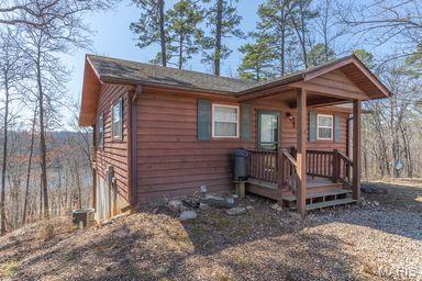 Discover your dream retreat in Van Buren, Missouri! This charming 3-bedroom, 2.5-bath cabin offers a perfect blend of comfort and rustic appeal. The open concept living area creates a welcoming atmosphere. The well-appointed kitchen is ideal for family gatherings and leads directly to a spacious covered deck at the back—perfect for relaxing or entertaining. Enjoy the convenience of a walkout basement that provides additional living space or storage options. The master suite includes a private bath, while the two additional bedrooms share a thoughtfully designed bath. A detached garage offers ample space for vehicles or hobbies. This cabin is ideally situated near the scenic Current River, making it perfect for fishing, canoeing, boat riding, and enjoying nature. Don’t miss this opportunity to own a slice of paradise! Call today before gone tomorrow!!