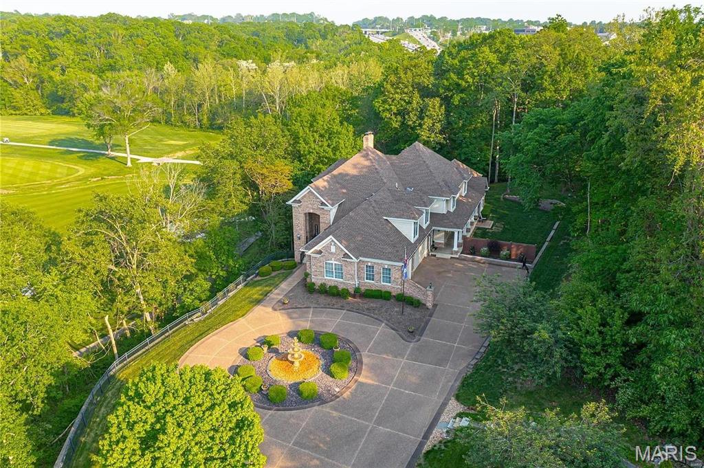 Rare opportunity to own a private, luxury home w/ stunning views of Sunset Hills Golf Course from every level. As you enter the grand foyer, you'll be greeted by a formal great room featuring a two-story fireplace. This home offers over 7,000 sq. ft of living space, including 4 beds & 5.5 baths. The main floor boasts a primary suite, spa bath & walk-in closet. Gourmet kitchen w/ premier appliances, center island &  breakfast bar open to family room. Breakfast area includes custom built-ins w/ workstations & leads to covered deck overlooking a private oasis. Main floor also includes mudroom, laundry room & oversized 3 car garage with EV charging station. Upper level offers spacious loft for additional seating, 3 bedrooms & impressive home theater for endless movie nights. The finished walk-out LL is an entertainer's dream:  recreation room, family room, wet bar, playhouse, 1/2 bath, & a unique and secure wine cellar/tasting room! There is also room to expand in the LL! Heaven in 63127! Additional Rooms: Mud Room, Wine Cellar
