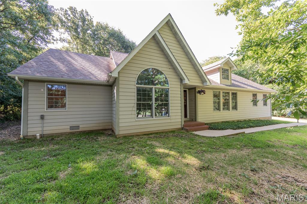 Welcome to this beautifully maintained Ranch home offering the perfect blend of comfort, charm, and convenience. Located just moments from the golf course, this property sits on a serene, wooded lot that provides privacy and a picturesque setting. Inside, you’ll find four generous bedrooms and three full bathrooms, including a Jack-and-Jill bath that adds both style and practicality. The heart of the home is the stunning family room/sunroom, filled with natural light and overlooking the peaceful backyard. Step outside to the spacious concrete patio—ideal for outdoor gatherings or quiet evenings surrounded by nature.  A cozy wood-burning fireplace anchors the main living area, creating a warm and inviting atmosphere. This home offers the space, setting, and features that make everyday living feel like a retreat.