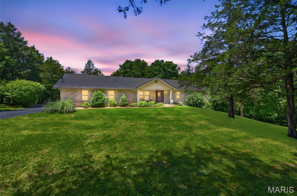 Tucked away on approximately 4 private acres in the Hillsboro School District, this spacious and well-maintained 4-bedroom, 4-bath home offers the perfect blend of comfort, privacy, and functionality. With over 2,200 sq ft, multiple living spaces, and extensive parking and storage options, this property is ideal for those wanting room to spread out both inside and out.

Inside, you'll find vaulted ceilings, warm wood flooring, and large windows that bring in natural light throughout the home. The spacious living room features soaring ceilings, skylights, and a beautiful fireplace, creating a warm and inviting gathering space. The kitchen offers granite countertops, updated backsplash, ample cabinetry, and great flow into the dining area, making it ideal for everyday living and entertaining alike.

The main-floor primary suite features vaulted ceilings, private deck access, and a spacious bathroom complete with a soaking tub and separate shower. Main-floor laundry adds everyday convenience.

The partially finished walk-out basement expands the living space with an additional bedroom and full bathroom, plus a bar area already started with plumbing roughed in for a sink. Plenty of unfinished space remains for storage, hobbies, or future finishing potential.

Outside is where this property truly shines. Enjoy the large deck overlooking the wooded setting, tons of parking, an oversized 2-car garage, and an impressive 40x28 covered carport with trench drain — perfect for additional vehicles, boats, campers, equipment, or workshop use.

Recent updates include:

New roof (2024)
New AC & furnace (2023)
New main-level windows (2022)
New deck joists (2024)
Granite countertops & backsplash (2014)
Septic recently serviced
Driveway recently resealed

Located in a private neighborhood with convenient highway access and surrounded by mature trees, this property offers the peaceful setting buyers are looking for while still being close to town.