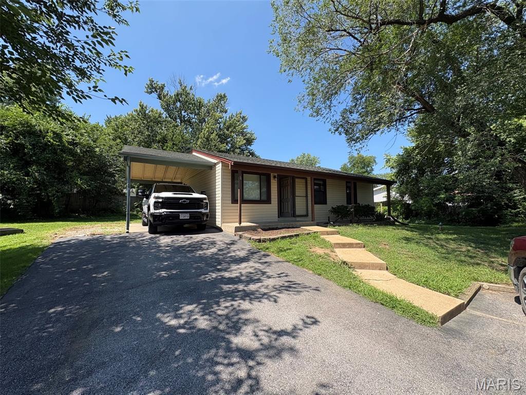 Right price + the right location = The right home for you!!  This home features 3 bedrooms 2 bathrooms, wood floors in living room and vaulted living room and kitchen. Other features include new carpet in the bedrooms, mostly finished lower level with bar area and new carpet in the family room and stairs, basement laundry room, and a rough in for an additional bath. Outside you with find a covered front porch, carport, an area next to carport that looks big enough to widen for extra parking, and backyard with a patio the backs to common ground.