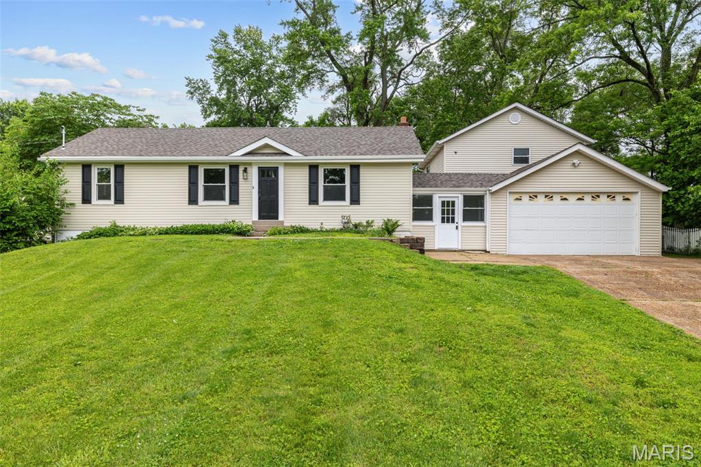 Welcome to this completely renovated home in Maryland Heights! Situated on nearly half an acre, with an oversized three-car garage, this home has room for all of your hobbies and vehicles. You'll have great curb appeal with a new roof and landscaping leading you inside. Enjoy hosting gatherings in the open layout of the main living space, with the living room flowing seamlessly into the dining room and kitchen. Updates include new flooring, stylish lighting, stainless steel appliances, quartz counters, black fixtures, and a timeless tile backsplash. The primary bedroom has an en-suite bath with tile-surround step-in shower, new vanity and flooring, and updated lighting. All three spacious bedrooms have ceiling fans and new flooring. Another updated bath with a tile-surround tub completes the space. A few steps down from the kitchen is a large mud room/breezeway connecting the home to the amazing garage space. You'll even have a partially finished upstairs space above the side-entry garage that's perfect for hobbies or projects, or to be finished out and turned into a true carriage house. There's even more storage space in the cleaned and painted basement. Enjoy the summer grilling with friends and family on the expansive patio shaded by large trees and overlooking the large fenced backyard. Located just moments from parks, schools, and restaurants, you'll have quick access to highways, Westport, and all of the shopping and restaurants along Lindbergh and St. Charles Rock Road. Don't miss out on this wonderful opportunity!