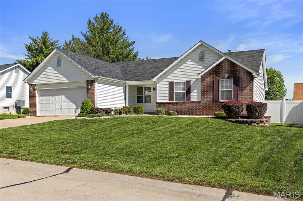 Welcome home to this spacious and well-maintained ranch in the desirable Calumet Ranch subdivision, within the Fort Zumwalt South school district. This 3-bedroom, 2-bath home offers over 2,500 sq ft of total living space, including a finished lower level—perfect for everyday living and entertaining.
Step inside to find a bright, open great room and dining area featuring vaulted ceilings, wood flooring, and a gas fireplace that anchors the space. The kitchen is thoughtfully designed with a center island, ample cabinetry, tile flooring, and a large pantry, opening to a breakfast room with a bay window that walks out to a stamped concrete patio and level backyard. The primary suite includes a generous walk-in closet and an updated ensuite bath with double sinks, tile flooring, and a separate tub and shower. Two additional main-level bedrooms and a full bath provide comfortable accommodations for family or guests, along with the convenience of main-floor laundry. Downstairs, the finished lower level offers a large rec/family area, two additional rooms ideal for a home office, gym, or hobby space, plus abundant storage and a rough-in for a future bathroom. Recent updates include a newer HVAC system and hot water heater, and the home has been freshly painted for a move-in-ready feel. Conveniently located near parks, shopping, dining, and major highways, this home delivers space, functionality, and a great location. Don’t miss your chance to make 229 Thoroughbred Trail your next home!