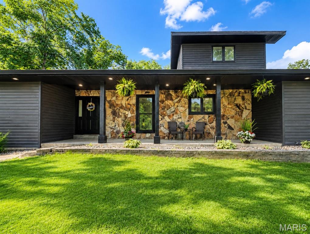 Rarely does a property like this become available. Nestled on nearly 5 private, wooded acres, this exceptional 1.5 story home offers a distinctive floor plan designed for flexibility and everyday living.

The upper level features an open loft style primary suite overlooking the dramatic great room, complete with an ensuite bath and two walk in closets. The walk out lower level offers a private guest or secondary suite with a spacious sleeping area, full bath, walk in closet, and adjoining hallway that creates separation from the main family room. A dedicated office and generous storage area add even more flexibility for working from home, hobbies, or multigenerational living.

The main level includes three additional bedrooms, a full bath, soaring vaulted ceilings, a dramatic floor to ceiling stone fireplace, and an open kitchen with a large center island that flows seamlessly into the main living spaces. Expansive windows fill the home with natural light while showcasing the surrounding wooded setting.

Outside, enjoy nearly five private wooded acres with plenty of room to entertain, explore, or simply relax. A spacious three car garage provides ample storage for vehicles, recreational equipment, and hobbies.

Conveniently located with easy access to shopping, dining, parks, and major highways, this property offers a rare combination of privacy, acreage, and versatile living spaces. Homes with this level of flexibility and nearly five wooded acres rarely become available.