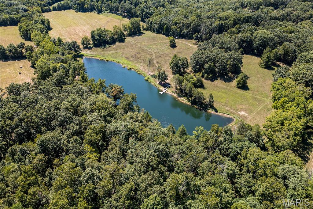 Lazy H Ranch, a rare opportunity to own 132 private acres just three miles south of Steelville, Missouri. Property offers the perfect mix of mature timber, open pasture, trails, and abundant wildlife with excellent deer hunting. Water is a standout with a stocked 2.5-acre lake with a dock perfect for fishing, a swim or put your kayak or small boat in for a float.  Plus two additional ponds, and seasonal creeks that enhances both beauty and function. A private drive ensures complete seclusion and privacy.  The home is a 3-bedroom, 2-bath barndominium with an open-concept floor plan, 1.5 story, designed for comfort and easy living. The home includes an oversized garage, perfect for equipment, recreational vehicles, or workshop space. The deep front porch expands the length of the house and offers exceptional porch-sitting with peaceful views of the surrounding land.  Located close to town conveniences while feeling worlds away, Lazy H Ranch offers a rare combination of privacy, accessibility, and natural beauty. Properties with this acreage, water, and improvements — this close to Steelville — are increasingly hard to find. Duplicate listing# 26001290

Shown by appointment only.

Includes (4) parcels: 15-3.0-06-0-00-008.000 ; 15-3.0-06-0-00-008.010 ;14-1.0-12-0-00-007.010;15-3.0-07-0-00-003.000