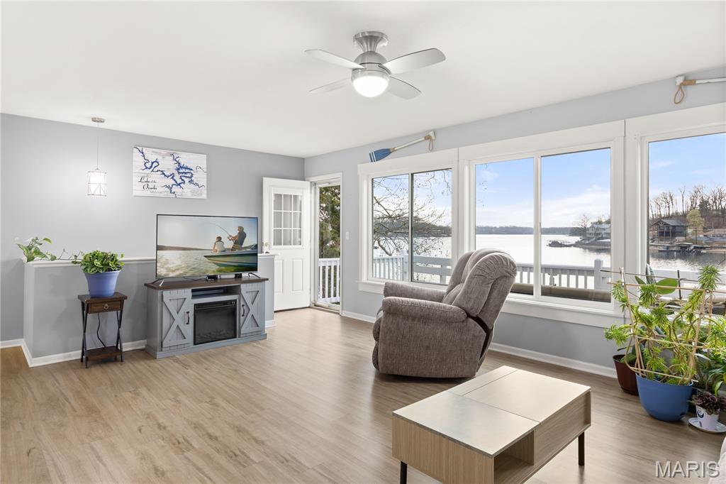 Discover the ultimate lakefront retreat with this stunningly remodeled 4-bedroom, 2-bathroom ranch, perfectly positioned at MM 5.5 in Lick Branch Cove. This residence offers a rare combination of BIG views and incredible DEEP water (25–30 ft), providing an exceptional environment for boating and swimming alike. Every inch of this home has been polished to perfection. The interior boasts a comprehensive remodel featuring updated flooring, contemporary lighting, and high-end windows that flood the space with natural light. The gourmet-inspired kitchen and baths shine with new cabinets and sleek countertops, offering a "fresh and clean" aesthetic throughout. Step outside to your private aquatic playground: a 2-well dock (10x28 & 8x8 PWC) equipped with a boat hoist, PWC hoist, swim platform, and wet steps for easy water access. Situated in a peaceful neighborhood on a well-maintained road, the property provides ample parking and effortless access to the shoreline. Whether you are looking for a tranquil full-time residence or a high-energy vacation getaway, this lakefront treasure is move-in ready. Bring your tape measure and see the depth for yourself—this is the one!
