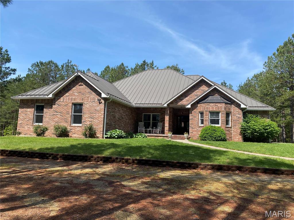 Welcome to a once-in-a-lifetime property offering 123 acres (+/-) of natural beauty, privacy, and versatility. Nestled among serene pine trees & boasting breathtaking views of the lake, this 4-bedroom, 3.5-bath custom-built home is your personal haven. Inside, you'll find a spacious layout with a bright sunroom, a chef's kitchen with Corian countertops, custom cabinetry, & SSA. The full basement includes a cozy family room, bathroom, & a large unfinished area perfect for additional bedrooms, game room, gym or a theater. Outside the possibilities are endless. A separate shop/shouse adds even more value & flexibility to the property. It features cove heating, A/C, a spot for a wood stove, full bath, making it ideal for use as an in-law suite, guest quarters, or a profitable Airbnb. Designed with high-end features and timeless finishes, including Geothermal HVAC, some heated tile floors, central vac, standing seam metal roof, & all brick exterior. 
duplicate listing MLS#25028051