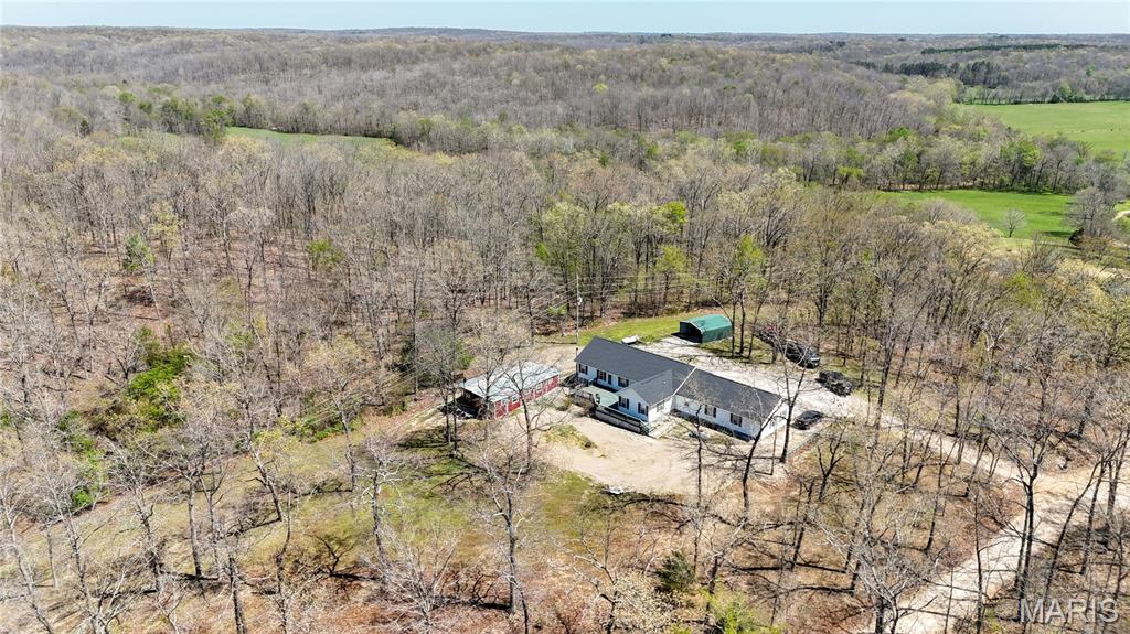 Set on 38 scenic acres in Grassy, Missouri, this beautifully updated 1,676 square foot home offers the perfect blend of comfort, privacy, and outdoor recreation. The home features a spacious layout with large bedrooms, an expansive living room, and is well-finished throughout with several updates.

Recent upgrades include a new roof, new septic system, fresh flooring, new paint, and numerous additional improvements throughout the home. Central heat and air ensure year-round comfort, while the exterior wood stove provides an alternative backup source of heat.

Step outside and you'll find a property that is truly catered for outdoor enthusiasts. This tract has great opportunities for deer and turkey hunting, a stocked pond for fishing, and direct private access to several hundred acres of Castor River Conservation Area - perfect for hunting, hiking, and exploring. Located less than three miles from the Castor River and just a short drive to Marble Hill, this property combines rural seclusion with convenient access to nearby amenities.

Whether you're looking for a full-time residence, hunting retreat, or recreational getaway, this property is a rare opportunity to own a versatile piece of Southeast Missouri land.