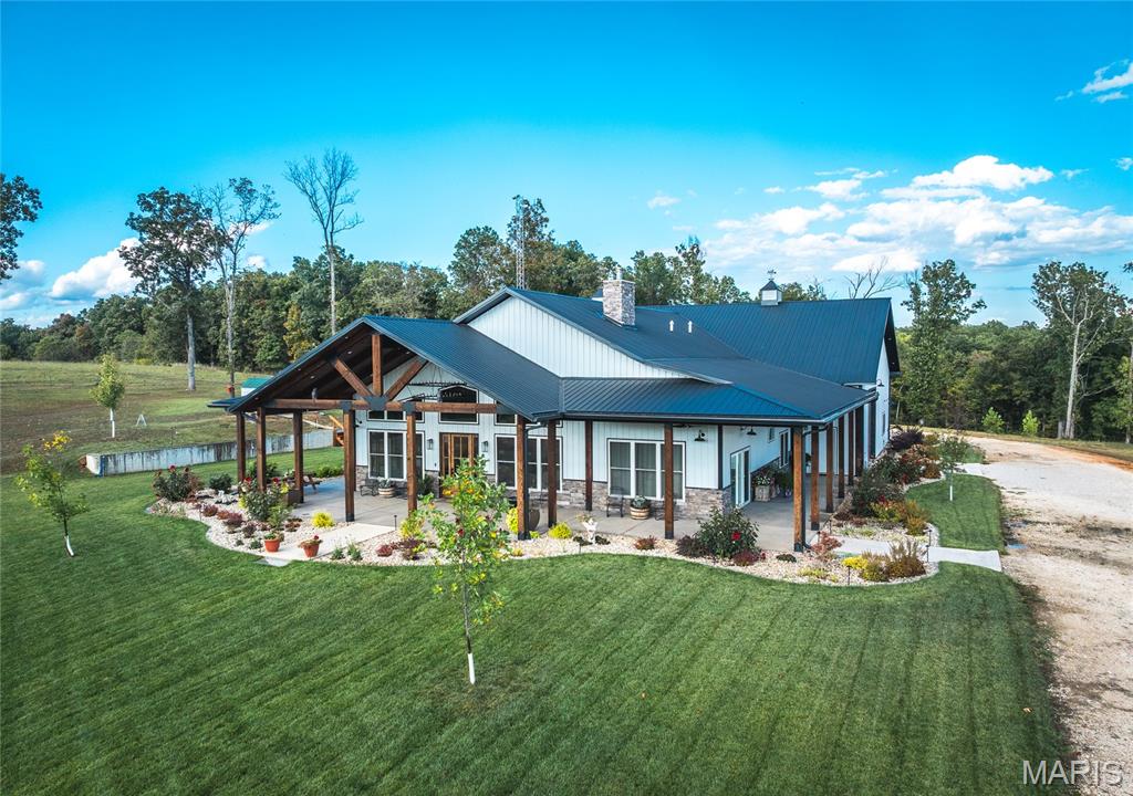 Located on 200 m/l pristine acres of rolling Missouri countryside, this one-of-a-kind private estate offers the perfect blend of luxurious modern living, timeless craftsmanship, and unparalleled outdoor recreation. At its heart stands a stunning barndominium-style home totaling 5,000 square feet, featuring a spacious 2,000-square-foot, 3-bedroom, 2-bath residence seamlessly connected to a massive 3,000-square-foot attached shop. This is more than a home — it’s a meticulously crafted, nearly maintenance-free sanctuary designed for those who appreciate beauty, privacy, and functionality.

Step inside the residence and be captivated by high-end finishes and thoughtful details throughout. The kitchen showcases elegant quartzite stone countertops, while granite stone surfaces grace the remaining areas. Polished concrete floors flow seamlessly underfoot, offering durability and modern elegance. A charming 100-year-old restored stained glass door on the pantry adds a touch of historic character and artisanal beauty. Stay cozy year-round with a wood-burning stove. No corners were cut in the building of this home — the walls are fully spray foamed for maximum efficiency, and the property is equipped with a complete security camera system.

The attached 3,000-square-foot shop is a standout feature, complete with its own independent HVAC system (separate from the house), making it ideal for hobbies, vehicle storage, workshops, or entertaining. A second driveway provides convenient access to two additional outbuildings: a 30x30 and a spacious 50x70, offering excellent flexibility for equipment, storage, or projects.

Outside, the grounds are nothing short of spectacular. Professional landscaping, designed by an architect, surrounds the home with lush, fully irrigated lawns and timed outdoor landscape lighting that creates beautiful evening ambiance. Roughly 40 acres of open pasture and multiple ponds enhance the natural beauty and offer peaceful retreats. The remaining acreage is a hunter’s paradise, renowned for excellent deer and turkey hunting with several great pinch points and established food plot locations in a highly private setting.

Just a short drive from the Lake of the Ozarks, this estate provides effortless access to world-class fishing, boating, and endless outdoor adventures while maintaining a secluded, peaceful atmosphere.

A truly unique and high-quality country estate built with pride and attention to every detail.