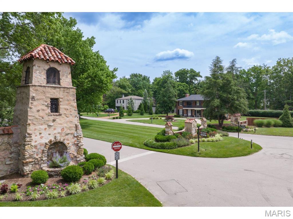 Is there a better location for urban living in the entire metropolitan area of St. Louis?  NO !  Great schools, parks, restaurants.  The lush trees of Ladue and this gourgeous neighborhood with its park setting at your front door provide an environment that is walkable and beautiful.  These photos speak for themselves.  Most important, this home is an updated delight.  Large living spaces.  The kitchen is architecturally stunning.  8 foot pour in the basement with its walk-out.  4 bedrooms, 3.5 baths.  Many, many details including a separate bar, bookshelves, lighting all add to the highend quality of this well laid-out home.  The large 2 car garage is accessible off Price Road in the back of the home.  This drive and the front drive are new.  New roof.  Beautiful landscapes.  Beautiful iron balconys.  The back yard is ideal for entertaining and play !!  A neighborhood second to none as you enter through its Spanish gates and tower.  This is a rare opportunity.