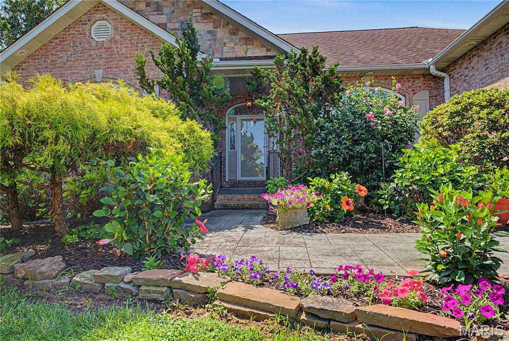 Something's special about this one. That thought will come to mind as you approach the front door of this stunning 4 bedroom, 3 bath home. The landscaping shows just how spectacular summer foliage can be, and sets the tone for all that follows. Stepping into the foyer, you'll be greeted by a crisp, airy and open floorplan and sparkling natural light. You'll be able to invite friends and family to gather here: comfortable living room space, a dining area that accommodates a large table, room for an additional table and a breakfast bar offer space for everyone. The kitchen was also made for entertaining, with its gas stove, warming oven, additional ice maker, and custom cabinetry. Still need more seating? The garage is tiled, heated and cooled, so people will be as comfortable there as your cars. The primary ensuite has tray ceilings, a walk-in closet, and separate tub/shower. The two additional main level bedrooms are on the other side of the house for maximum privacy. Main-level laundry with sink connects the living area with the garage for convenience. And that lower level? A wet bar and large open family room with space for ping-pong, pool or workout equipment walks out to the level back yard. An additional bed and bath, plus large storage area and John Deere door complete the interior. So much space, so meticulously maintained! Yep, there's something special about this one - come see for yourself.