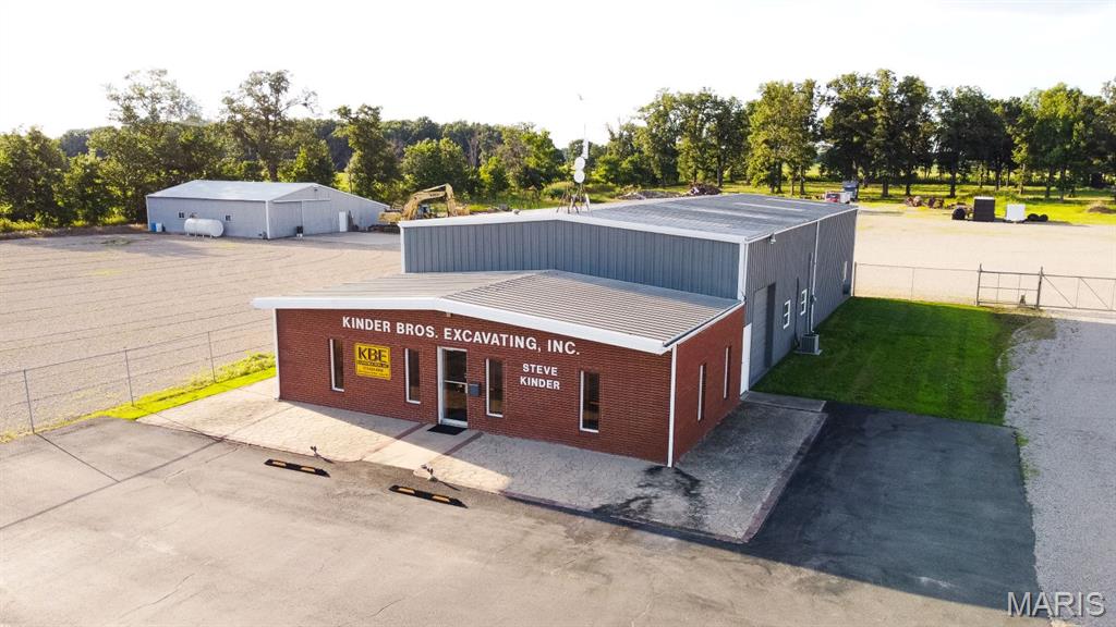 This Commercial Property has a ton of versatility and offers you the opportunity to own a property along Highway 60 W just outside City Limits of Dexter, MO.  This highway is located along the future I57 and you won't find another property like this one!  It has been used as an Excavator/Construction business, so it has multiple buildings which may be beneficial to you.  Building 1:  a Brick/metal building, faces the highway, with a waiting area entry, 5 offices, a conference room, a break area, 2 bathrooms, in the front and an open garage in the rear with an upstairs area for storage or for future office space.  It has a large overhead door leading to the gravel, fenced parking area in the back.  Quality construction with wood, 6-panel doors, Oak cabinets, a great floor plan for multiple people working throughout the building without being "crammed" in a small space and disturbing others while working.  Building 2:  Step on this covered front porch and you will want to sit, relax, and watch traffic as it passes your future business.  This was built in 1988.  It was formerly a Quilt Shop and now is used as a personal quilting area for the owner.  It has a carpeted "great" room, an office, a large room in the rear, an office, and a storage room/garage in the rear of the building.  It too has a large garage door which also opens to the same gravel, fenced parking area.  Locked inside the fenced area, to the west of the main building, you will find a Warehouse/Shop which is 2400 sq ft.  with a 900 sq ft covered lean-to.  Don't miss your chance to move your business to this prime location.