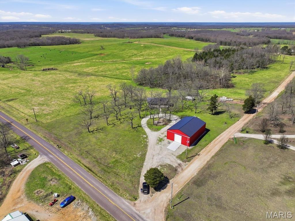 Country living at its finest! Nestled in a peaceful setting where wide-open skies and tranquil surroundings create the perfect backdrop for everyday life, this beautiful 4-bedroom, 2-bath home offers the ideal blend of comfort, functionality, and rural charm. Imagine starting your mornings with a cup of coffee on the inviting front porch as the countryside comes to life around you. In the evenings, unwind on the spacious back deck while taking in stunning sunsets and the peaceful sounds of nature. This is the kind of property that encourages you to slow down, relax, and enjoy the simple pleasures of country living. Inside, thoughtful updates enhance both comfort and efficiency. New windows and sliding glass doors fill the home with natural light while helping improve energy performance. Additional R-59 spray-in attic insulation provides year-round comfort, creating a home that feels as practical as it is welcoming. For those who need space to work, create, or store equipment, the impressive 60' x 40' heated and cooled shop is a true standout feature. Whether you're running a business, pursuing hobbies, restoring vehicles, or storing recreational equipment, this versatile space is ready to accommodate your needs. Durable 6-inch concrete floors, a 14-foot garage door, a mini-split system, and a pellet stove make it functional and comfortable in every season. If you've been searching for a property that offers privacy, modern updates, and room to live, work, and play, this exceptional country retreat is one you won't want to miss. Schedule your private showing today!
