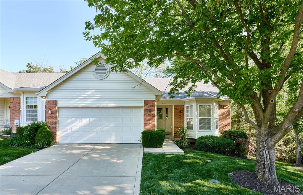 Meticulously maintained ranch at a quiet location at the end of the street, backing to mature trees. This beautiful home features a vaulted entry with leaded glass door, wide plank wood flooring, and an open, light-filled floor plan. Off the entry foyer is a living room/office with pocket doors.  The great room/dining room combination offers a vaulted ceiling, gas fireplace, and recessed lighting, flowing seamlessly into the kitchen with 42" cabinetry, solid-surface countertops, breakfast bar, and pantry. Laundry room with cabinets and laundry sink is conveniently located off the kitchen. Main floor primary suite includes a vaulted ceiling, bay window, walk-in closet with custom organizer, and an updated ensuite bath with double vanity and walk-in shower. The finished lower level boasts a large family room with look-out windows, 9' bar with cabinetry and sink, additional bedroom, full bath, and abundant storage. Enjoy outdoor living on the deck with vinyl railing and peaceful wooded views. Walk to Daniel Boone Library and nearby shops/restaurants at Clayton & Clarkson. Exceptional location, thoughtful updates, and move-in ready!