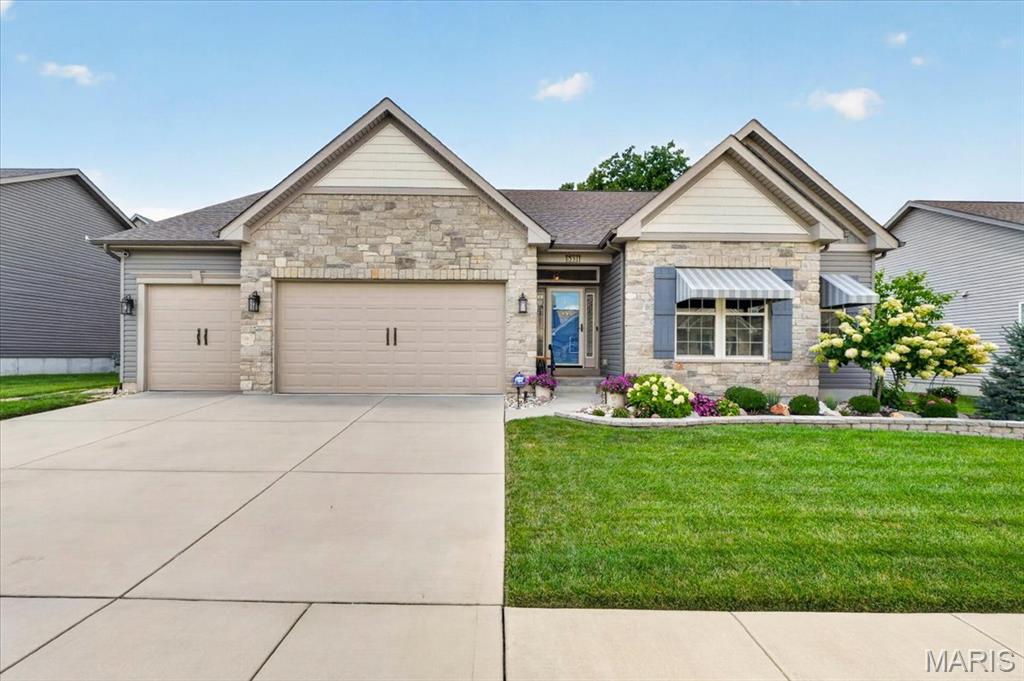 Welcome home to effortless luxury in the desirable Wilson Estates community. Just six years young, this meticulously maintained ranch offers the perfect blend of quality craftsmanship, timeless finishes, and comfortable one-level living in a quiet one street neighborhood. From the moment you arrive, you'll appreciate the beautifully landscaped yard, custom energy-efficient awnings, and oversized 3-car garage with durable epoxy floors. Inside, an inviting open floor plan is filled with natural light, highlighted by rich hardwood flooring, soaring vaulted ceilings, elegant porcelain tile, and a stunning stone gas fireplace that creates a warm gathering space. The thoughtfully designed kitchen is as functional as it is beautiful, featuring custom cabinetry with glass accents, imported granite countertops, a spacious center island with breakfast seating, GE Café gas range, porcelain subway tile backsplash, walk-in pantry, planning desk, and abundant workspace for everyday meals or entertaining family and friends. Step outside to your own private backyard retreat. The covered patio, complete with ceiling fan, custom shades, and French door access, offers the perfect place to enjoy morning coffee or unwind in the evening. Professionally landscaped grounds, mature trees, black metal fencing, a stone retaining wall, arbor with lighting, grilling area, and raised organic garden create a peaceful outdoor oasis with plenty of privacy. The spacious primary suite provides a relaxing escape with a large walk-in closet and spa-inspired bath featuring dual vanities, an oversized walk-in shower, porcelain tile finishes, and a private water closet. Additional bedrooms offer flexibility for overnight guests, hobbies, or a dedicated home office. The expansive lower level is ready for future living space with 9-foot ceilings and an already completed full bath featuring a soaking tub, stylish vanity, and elegant wainscoting—ideal for creating the perfect recreation room, guest suite, or entertaining area. Exceptional updates and premium features include plantation shutters, front and rear irrigation, security system, energy-efficient window film, Bosch dishwasher, new premium siding and fascia (2025), and countless custom upgrades throughout. Located in the heart of Oakville, this exceptional home offers the quality, comfort, and easy living you've been searching for—all in a welcoming neighborhood you'll be proud to call home.