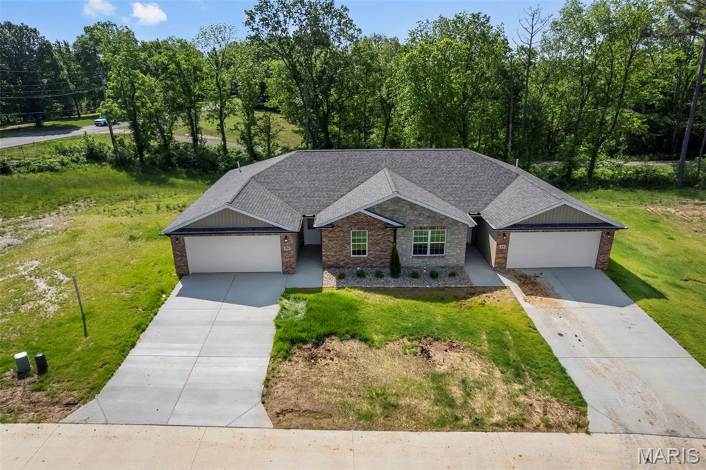 Newly constructed duplex at 35 & 39 Benton Hill Lane in Cape Girardeau, MO presents an outstanding opportunity for both investors and owner-occupants seeking quality construction and income potential. Each unit offers 2 bedrooms and 2 full bathrooms with approximately 1,266 finished square feet per side, featuring a well-designed open floor plan that blends comfort and functionality. Interior finishes include ceramic tile flooring, quartz countertops, modern appliances, and sleek glass shower doors, all selected to provide a clean, contemporary feel. The exterior is highlighted by a brick front, attractive landscaping, and a newly seeded yard, positioned on a desirable lot that enhances curb appeal. Located just minutes from shopping, dining, and everyday conveniences, this property is well-suited for generating steady rental income—whether you choose to occupy one side and lease the other or add both units to your investment portfolio for long-term returns. Seller is willing to consider selling additional units, offering a great opportunity to expand your real estate holdings.