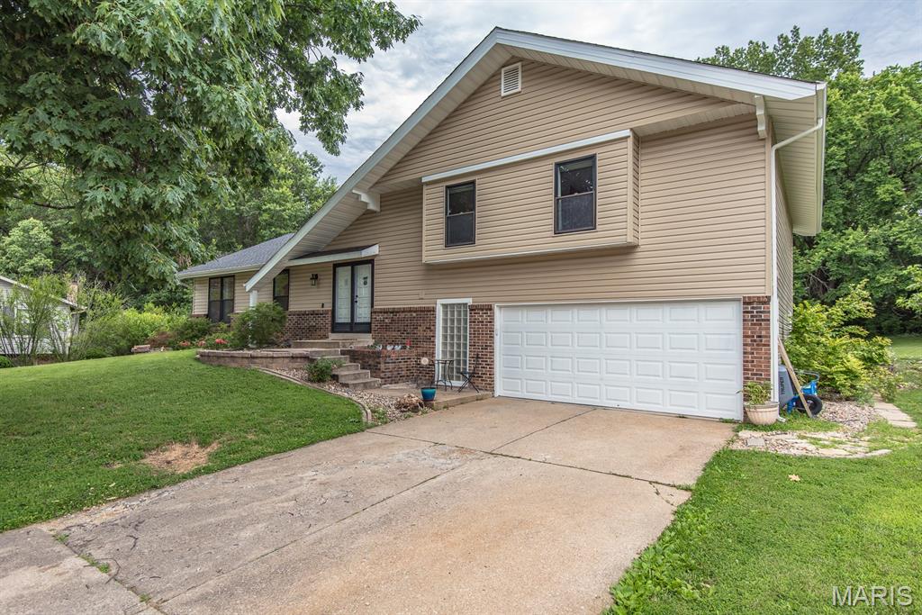 Tons of living space and bonus storage space in the multi-level home located on a nice court.  Gorgeous white kitchen with stainless appliances, granite countertops, and breakfast room with picture window overlooking your large backyard backing to trees and woods.  Formal living room and dining room.  Vaulted ceilings and fireplace in the main family room.  Spacious deck space.  Upstairs 3 large bedrooms, updated hall bathroom.  Primary owners suite has walk in closet, double sink and vanities and private balcony off this bedroom to enjoy your evenings or morning views of the private backyard.  4th bedroom and 3rd full bathroom and laundry room on a lower level.  Then you have the bonus basement storage area that is a walkout and unfinished.  Great court, great yard, nicely update home, spectacular location.