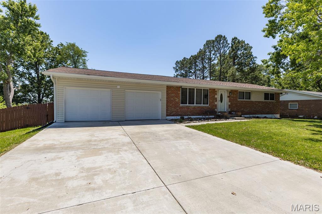 Tucked away on a quiet private street, this sprawling brick ranch feels like the kind of home where life just happens naturally. From the moment you pull up, the mature shade trees, beautiful landscaping, and inviting curb appeal make you want to slow down and stay awhile.

Step inside and you’ll immediately notice the oversized picture window filling the living room with natural light — the perfect spot for cozy movie nights, holiday gatherings, or cheering on your favorite team. The kitchen and dining area have the warmth everyone is looking for, complete with a wood-burning fireplace, breakfast bar, pantry, and stainless steel appliances that make everyday living feel comfortable and connected.

Just off the kitchen, you’ll love the practical mud room, bonus office space, and easy garage access that make busy days run smoother. Open the sliding glass doors and the backyard becomes an extension of the home — a large covered patio ready for summer BBQs, game days, and evenings spent relaxing outdoors. The backyard is surprisingly private and spacious, with plenty of room to throw a football, let pets run, or simply enjoy the peace and quiet.

The primary suite offers a bright, relaxing retreat with its own ensuite bath, while the additional main-level bedrooms are generously sized with large closets. Downstairs, the finished lower level gives you endless flexibility with space for a family room, game area, workout room, or entertaining space. The full wet bar with sink, range, and mini fridge makes hosting easy, and there’s still plenty of storage throughout.

All of this in a location that keeps you close to shopping, restaurants, and an easy commute while still feeling tucked away from the hustle. Homes with this much space, warmth, and functionality don’t come along often — come see why this one feels like home the moment you walk in.