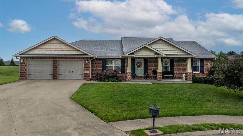 Custom built and tucked away in a quiet cul-de-sac, this all brick home offers exceptional quality, thoughtful design, and pristine condition throughout. An inviting front porch welcomes you into a spacious open floor plan featuring hardwood floors and a warm, comfortable great room. The large kitchen is designed for both everyday living and entertaining, complete with a dining area and additional seating at the island.
The functional main level layout includes three bedrooms, while a beautiful wooden staircase leads to the finished lower level featuring an additional expansive great room, two more bedrooms, and flexible recreation space perfect for entertaining, hobbies, fitness, or game nights. Car enthusiasts, hobbyists, or those needing extra storage will appreciate the tandem garage on the main level along with the additional small garage area in the lower level. This home truly stands out as an exceptionally well-built and designed property. Come take a look!