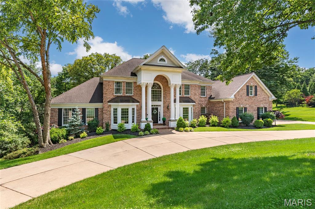 Spectacular, custom built 1.5-Story home, situated on a 1-acre cul-de-sac lot, backing to woods, in the desirable Topping Woods Estates – Top Rated Parkway Schools! This home boasts 6 beds, 5 full baths & 2 half baths with 6500+ sqft of living space, including the professionally finished walk-out lower level. Main floor finds formal dining room & living room, both with arched openings, wainscoting/moldings & large bay windows; a light & airy great room with cathedral ceilings, arched openings, fluted pillars & fireplace, flanked by floor to ceiling palladium windows. Gourmet kitchen with an abundance of custom cabinetry, quartz counters, tiled backsplash, stainless appliances, butler's pantry & planning desk, breakfast room, hearth room with barreled ceiling & fireplace. Fantastic primary retreat with back-lit coffered ceiling, a luxury bath with dual vanities, jetted tub & stand-alone shower, as well as dual walk-in closets. Upstairs finds 4 additional beds & 3 full baths, all with walk-in closets. Lower level includes a spacious rec room, wet bar, fireplace, fitness room/gym, 6th bed & 5th full bath. Highlights: zoned HVAC, central vacuum, alarm & irrigation systems, custom moldings throughout, walk-in cedar closet, professionally landscaped lot & oversized 3-car side-entry garage, with a 3rd staircase, providing direct access to basement! Large composite deck, with custom railings/iron balusters, expansive paver patio and picturesque outdoor living space.