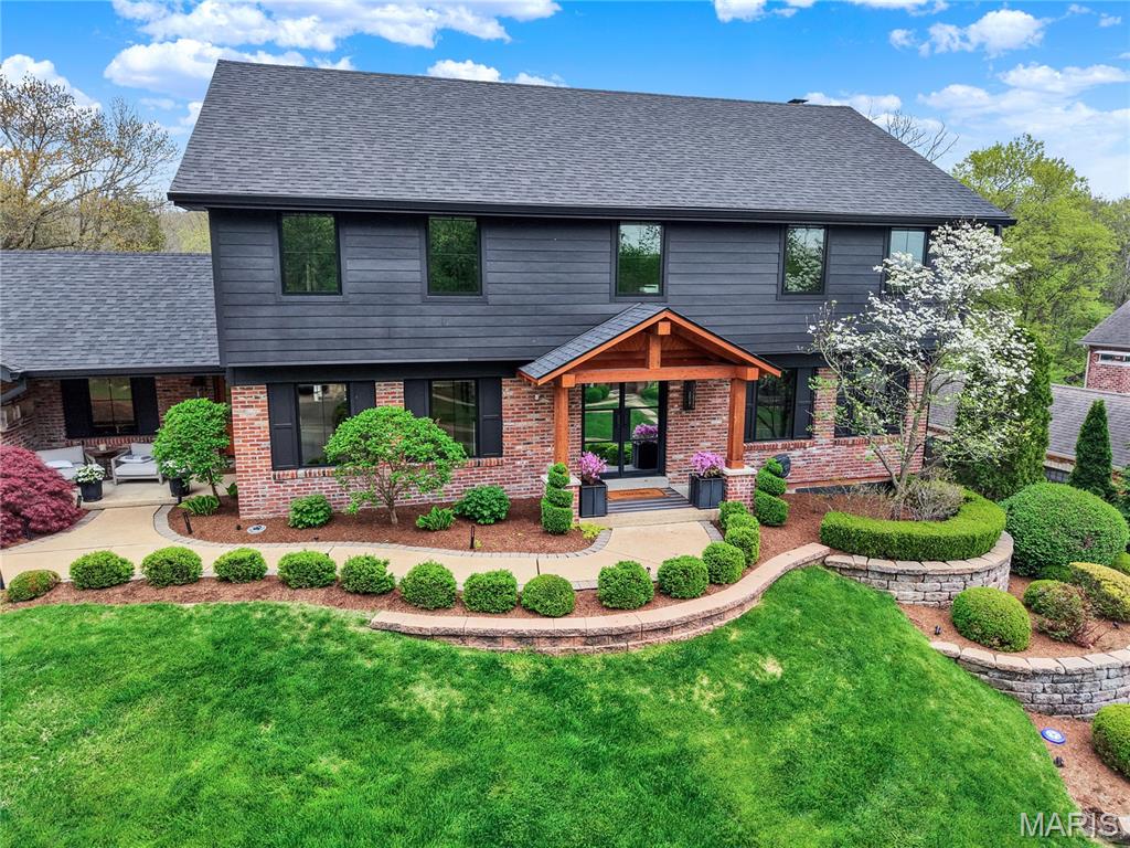 Nestled at the end of a quiet cul-de-sac and backing to completely private woods, this spectacular Contemporary Craftsman has been renovated from top to bottom with zero compromises. Every inch has been touched, every  and every space reimagined — delivering the feel of new construction with the warmth of an established neighborhood.
The main floor was opened up to create seamless living and dining spaces, anchored by re-sanded hardwood floors, a new fireplace, and a fully outfitted living room bar with sink, dishwasher, double beverage drawer, and ice maker. The chef's kitchen features a Thermador gas range and oven, Thermador dishwasher, built-in microwave, ice maker, and a butler's pantry with a KitchenAid second oven and warming drawer. New Hardie board siding, a new roof, all-new Pella windows with custom casing, new K-style gutters with square downspouts, new automatic shades, new iron front door, new garage doors, and completely redesigned mature landscaping with lighting complete a stunning first impression.
Upstairs, the primary suite was completely gutted and rebuilt — featuring a spa-caliber bathroom and custom floor-to-ceiling built-ins throughout the bedroom and closet. A second HVAC unit serves the upper level, and a fully remodeled second bathroom and new luxury vinyl tile flooring round out the floor.
The finished walkout lower level is an entertainer's dream — stepping directly out to the pool. A full bar with Sub-Zero-caliber refrigerator, ice maker, drawer dishwasher, and microwave anchors the space alongside a fireplace, movie room, additional bedroom, and a full bathroom with steam shower. The seamless indoor-outdoor flow makes this level the ultimate warm-weather entertaining hub.
Outside, a resort-style backyard backs to private woods with a stunning pool featuring all-new tile, coping, equipment, and heater. A fully equipped outdoor kitchen and bar — complete with new cabinetry, beverage drawer refrigerator, sink, built-in cooler, Bull barbecue pit on a dedicated gas line, pizza oven, warming drawer, Bull refrigerator, and large gas fire pit — create an outdoor entertaining environment that is truly second to none.
A finished and heated garage with epoxy flooring, whole-home Sonos system indoors and out, and professionally landscaped grounds with architectural lighting complete a home that is truly without equal in Town & Country.