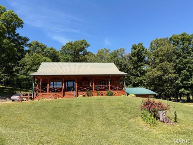 Tucked away in a breathtaking setting on 13 +/- scenic acres, this stunning log cabin retreat offers the perfect blend of rustic charm and peaceful country living. From the moment you arrive, you'll fall in love with the inviting covered front porch, ideal for soaking in the beautiful views and quiet surroundings. Inside, the home features soaring raised ceilings, warm wood finishes, and an open welcoming feel throughout. The loft-style area overlooking the main living space makes the perfect office, reading nook, or additional guest space. Offering 3 bedroom and 2.5 baths, this property was designed for both comfort and relaxation. A spacious 1200 +/- sq ft shop building with electric offers the perfect place to store boats, side by sides, equipment, and all your outdoor toys with room to spare. Enjoy mornings in the garden area, evenings on the covered porch, and endless privacy with adjoining wooded acreage surrounding the home. Located just approx. 2 miles from Current River, this property would make an incredible weekend getaway, Air Bnb investment, or your forever home. This is for those craving nature and tranquility; you will be sure to fall in love!