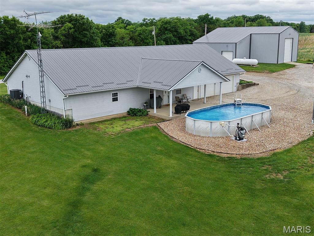 Escape to the perfect blend of modern comfort and country living on this stunning 5.5± acre property. Built in 2005, this beautifully designed 4-bedroom, 2-bath home features an open floor plan and modern finishes, creating a bright and inviting atmosphere. Stay comfortable year-round with energy-efficient in-floor radiant heat, and enjoy seamless indoor-outdoor living with a covered concrete patio overlooking your private 1±-acre stocked pond—perfect for relaxing evenings or entertaining guests. An above-ground pool adds even more appeal, making this property an ideal retreat for everyday living and weekend enjoyment alike.

Beyond the home, you’ll find exceptional outbuilding space designed to meet a wide range of needs. The first outbuilding, constructed in 2010, offers an impressive 2,400 square feet of shop space complete with a durable concrete floor, in-floor heat, and two insulated overhead doors. With the potential to add cooling, this versatile space is perfect for hobbies, equipment storage, or running a business right from your property.

A second outbuilding, built in 2020, expands your possibilities even further with 1,700 square feet of additional insulated shop space. Featuring 16-foot walls, two 14-foot-tall, insulated overhead doors, and two additional smaller overhead doors, this structure accommodates larger equipment, vehicles, or workshop operations with ease. Whether you’re seeking space to work, play, or simply spread out and enjoy the outdoors, this property delivers exceptional functionality, style, and freedom all in one remarkable package.