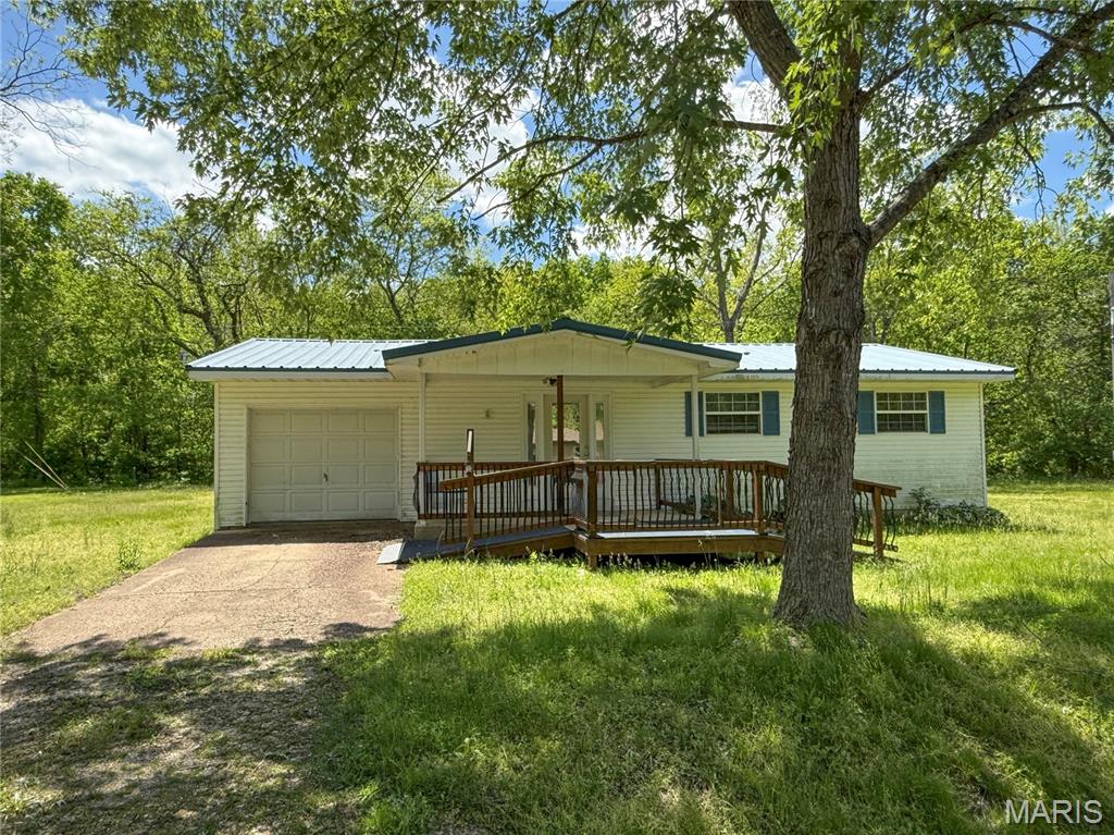 Tucked away at the end of a quiet street, this inviting 3-bedroom, 2-bath home offers the perfect blend of country charm and everyday convenience. Situated on nearly an acre, the property provides plenty of privacy and room to enjoy the outdoors.

The home features a kitchen with newer appliances, along with a newer water heater and water softener for added peace of mind. A durable metal roof adds long-term value and low-maintenance appeal. Inside, the functional floor plan offers comfortable living spaces, while the attached one-car garage and impressive 24' x 30' detached shop provide abundant space for vehicles, storage, hobbies, or workshop projects. Interior photos have been digitally enhanced and virtually staged.
