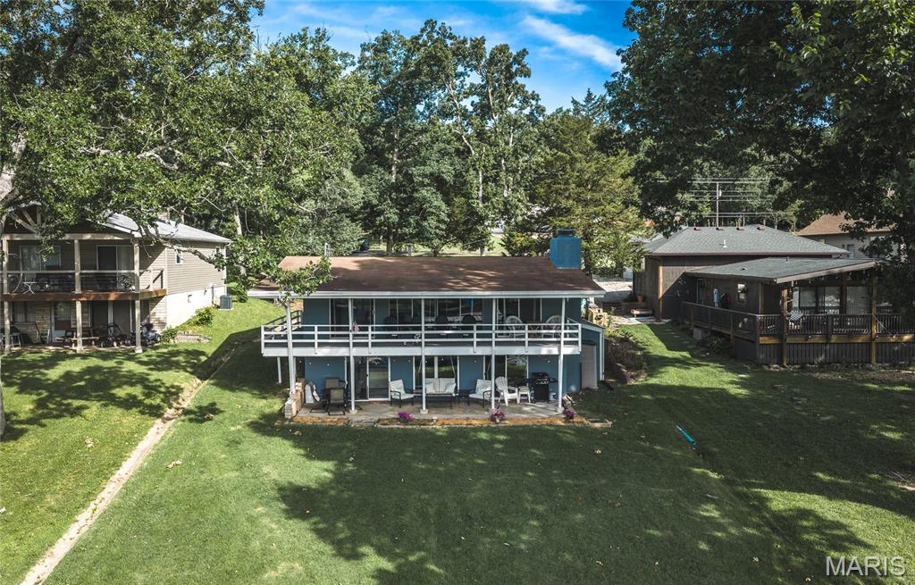 Schedule your showing NOW so you can enjoy the rest of the summer at the LAKE! This home hits all the critical things for a lake house! Enjoy an easy walk to your private dock, with boat lift and swim platform. Then jump right into the water in Cove 7 - or fish from the dock. Dock was installed in 2021 and boat lift in 2023. Jetski dock was installed in 2025. Just move in and enjoy these features! The home features living space on main level with a full bath and 2 bedrooms. Sliding doors to covered deck add living space. Downstairs is your kitchen, recently updated in 2022 to include cabinets, counters, sink, appliances, drywall and electric. This entire level had new luxury vinyl plank installed in 2022 as well. The dining area and additional living area can accommodate the entire family (and guests). A full bath and large storage area round out the lower level. From here, you can access the covered patio and a nearly level yard to get to the water. Also outside is a storage shed at the side of the house. These sellers will leave everything if the buyer wants it - so just walk in after closing and go jump in the lake! Indian Lake is a 326 acre (+/-) lake for boating, fishing, jet skis, skiing and tubing. The lake is stocked for fishing. A sandy beach area, playground pickleball/tennis courts, basketball court, horseshoe pits and full service marina round out the community. The community center hosts many events, including poker runs, trivia nights, rummage sales and potlucks, to name a few. It can also be rented for private events. The marina also has a general store to make lake life easy! The home has also been painted inside and out, electric service was upgraded in May of 2021, to include adding electric to the seawall. Septic has been service as recommended. Seller also has boat and jetski available for sale separately, just request details.