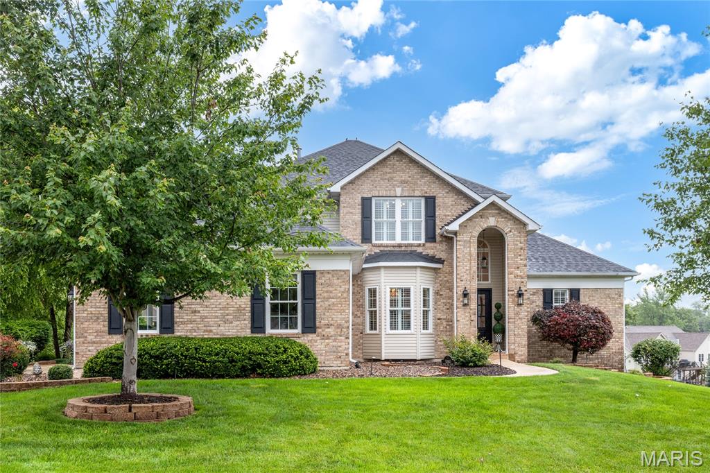 This classic-styled brick 1.5 Sty features exceptional craftsmanship & distinctive design elements throughout including handscraped hardwood flooring, soaring ceilings, detailed trim work & plantation shutters. Impressive 2-sty arched entrance leads to hardwood foyer, formal dining room and spectacular great room with cast stone fireplace & dramatic wall of windows. Designer kitchen featuring 42” glazed cabinetry, granite countertops, stainless steel appliances & crescent center island adjoins light-filled breakfast room & exceptionally large, vaulted hearth room highlighted by stacked stone fireplace. Coffered primary bedroom suite with wide bay window & luxury bath with expanded shower offers an appealing retreat. The 2nd floor extends the living quarters with 3 additional bedrooms, 2 with Jack n’ Jill bath, & hall full bath. Lower-Level entertainment space includes recreation room with floor-to-ceiling fireplace, game room & gathering bar plus office, flex room & full bath. Atrium doors open to outdoor living area with covered deck, patio with firepit, sport court, pool & pool house with grilling station & half bath.