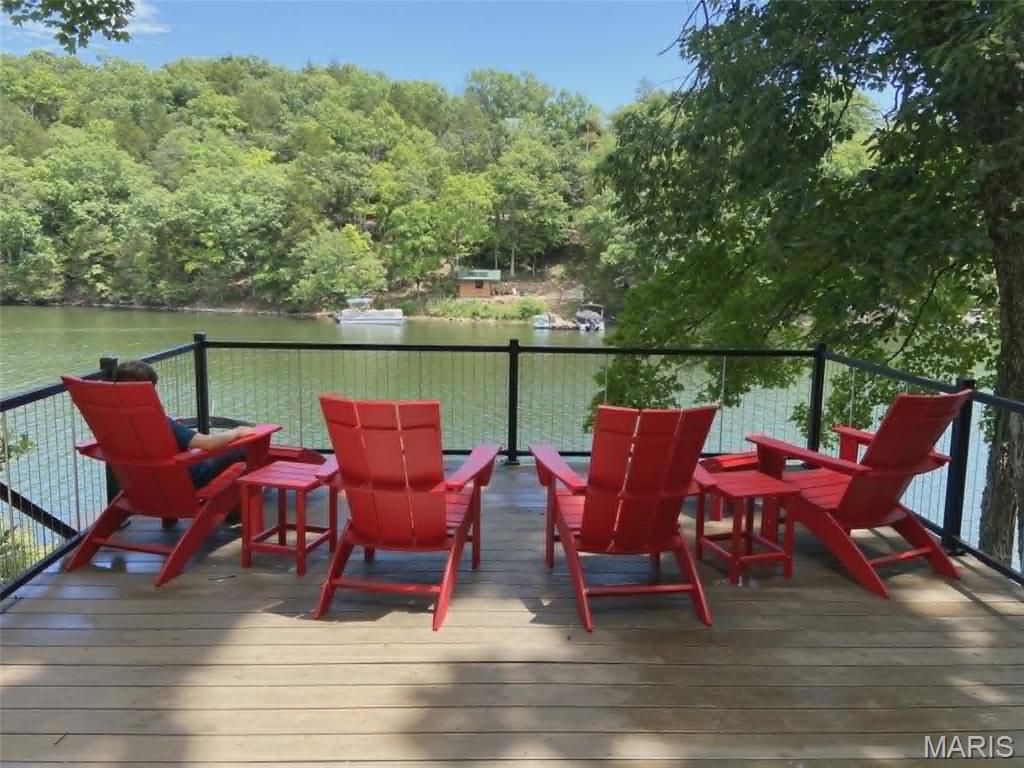 Rare opportunity to own an exceptional waterfront lot offering approximately .34 acres with over 100 feet of shoreline frontage and more than 100 feet of road frontage. This beautiful property is ideally situated on the main lake while tucked within a protected cove, providing deep water year-round and the perfect setting for boating, fishing, and relaxing lake days. Thoughtfully improved and ready to enjoy, the property features convenient off-street parking, water and sewer hookups, electric service already in place, and a brand-new storage shed. Natural rock and stone steps wind gracefully down to the water's edge, creating a stunning path through the landscape. Along the shoreline, you'll find a composite dock and multiple entertaining areas designed to maximize lake views and outdoor enjoyment. A spacious composite deck offers the perfect place to gather with family and friends while taking in the peaceful waterfront setting. Nestled within a 24-hour gated community, Lake Sherwood offers both privacy and peace of mind, along with access to an incredible array of amenities. Enjoy six beautiful lakes ranging from 3 to 130 acres—the main lake allows motorized boating, while the remaining five offer peaceful, non-motorized enjoyment. The community also features a newer club pool, clubhouse, campground facilities for overnight stays, a sandy beach area, Lakeside Grill with a full menu and a marina. The community offers year-round activities. Located within the highly regarded Washington School District, this property offers both convenience and charm. You’ll be just minutes from the quaint downtown of Marthasville and close to the scenic towns of Augusta, New Melle, and Washington. Plus, enjoy an easy 35-minute drive to Chesterfield and quick access to Missouri Wine Country’s finest wineries. Whether you're looking for the perfect waterfront getaway, a place to build your dream lake home, or simply a property to enjoy all that lake life has to offer, this one checks all the boxes. Enjoy the best of lake living with boating, fishing, swimming, and year-round recreation. Don't miss this chance to own a prime waterfront property with breathtaking views, deep water access, and outstanding improvements already in place.