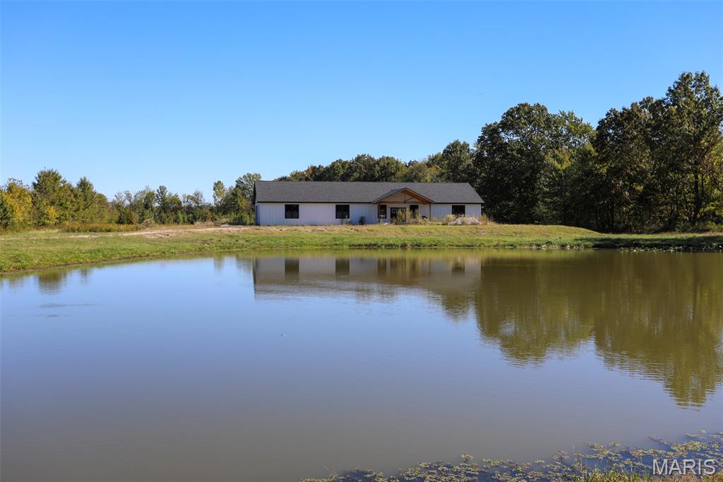 New Construction Awaits Your Vision on Secluded Marble Hill Road.

An exceptional opportunity awaits to secure a newly constructed, contemporary home poised for its finishing touches at 3108 Marble Hill Road. Located on the highly desirable northern side of Poplar Bluff, this estate sits on a private 6-acre parcel and offers the perfect blend of luxury, acreage and modern living. The spacious design boasts over 3,500 square feet under roof, featuring 3 bedrooms, 3.5 baths, and numerous specialized spaces designed for a flexible lifestyle. The stunning, open-concept kitchen is the heart of the home, showcasing premium custom cabinetry with generous storage and elegant granite countertops. Functionality is paramount, with a large, dedicated utility room and two luxurious primary suites, each featuring a custom-tiled walk-in shower. The layout further includes a versatile fourth room ideal for a nursery or home office, a large attached hobby area or flex space adjacent to the garage, and an essential 9x8 fully concrete safe room located conveniently off the kitchen. The private, natural setting is truly unparalleled, featuring a peaceful pond and abundant local wildlife, creating a serene sanctuary. Much of the hard work is complete, and the sale includes most of the necessary materials, such as fixtures, allowing the discerning buyer to immediately personalize and complete this dream home. This custom project offers privacy, space, and a premium location that is rarely found in new construction.