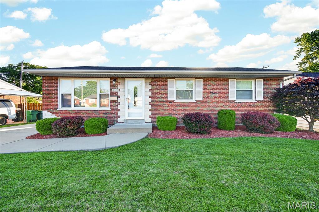 Welcome to this all brick ranch home with great curb appeal! Large window in the living room provides lots of natural light into the open floor plan. You’ll enjoy beautiful wood flooring throughout. Plenty of cabinet space in the kitchen, as well as a pocket door for privacy.  There is also a large pantry for extra storage. The primary bedroom has a half bath, and the remaining two bedrooms are served by an updated bathroom which includes a jetted tub. All of the bedrooms as well as the kitchen have ceiling fans. The lower level recreation area features a custom bar, complete with a wine fridge, beverage fridge and bar TV, all which stay with the home!  A cedar closet and laundry area finish off the downstairs area. In the backyard you’ll enjoy the exposed aggregate patio, fenced level yard and the oversized one car garage. HVAC is only 5 years old. This one won’t last long!