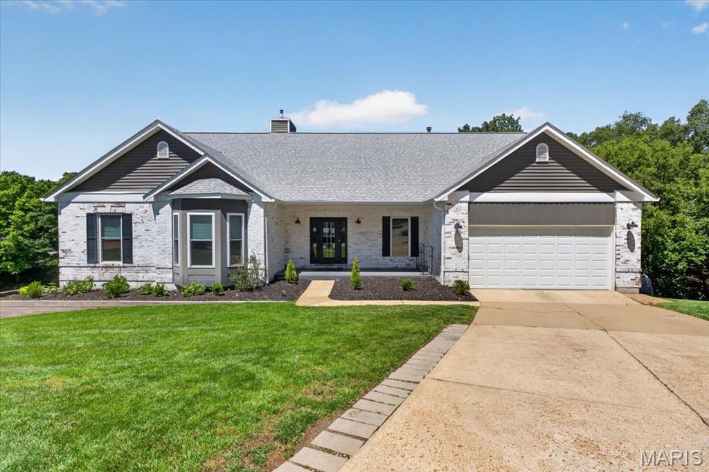 Immaculately maintained atrium ranch tucked away on a peaceful cul-de-sac and backing to mature trees for exceptional privacy and picturesque views! This impressive home offers an open, light-filled floorplan with soaring vaulted ceilings and a dramatic wall of windows that floods the great room with natural light. The inviting great room features a wood-burning fireplace and seamlessly flows into the dining area, creating the perfect space for both everyday living and entertaining. The beautifully updated kitchen is truly the heart of the home, showcasing quartz countertops, custom 42” cabinetry, center island, stainless steel appliances, and an adjoining breakfast room with access to the sunroom and composite deck overlooking the serene yard and wooded backdrop. Retreat to the spacious primary suite offering a large walk-in closet with custom organizers and an ensuite bath complete with dual vanities, soaking tub, and separate walk-in shower. Two additional bedrooms, an updated full bath, and convenient main floor laundry complete the main level. The finished walk-out lower level expands the living space with a large family room and game area featuring a wet bar and second fireplace, perfect for entertaining or relaxing. An additional bedroom, updated full bath, and abundant storage space make the lower level ideal for guests or multi-generational living. Additional highlights include a 2-car garage, desirable Rockwood Schools, and an unbeatable setting that combines comfort, privacy, and style.