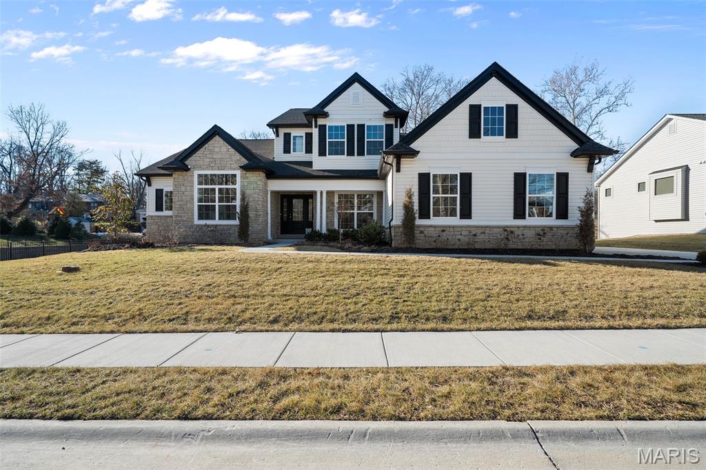 Conveniently located in Olivette and within award-winning Ladue Schools, this exceptional Freeman Homes new construction offers a rare blend of timeless elegance, thoughtful design, and elevated luxury. The architectural brilliance is immediately apparent, with an open yet intentionally defined floor plan that balances grandeur with everyday functionality.

The chef’s kitchen is the heart of the home, featuring top-of-the-line appliances, premium finishes, a large center island with bar seating, a spacious walk-in pantry, and a sunlit breakfast room that flows seamlessly into the stunning living room. Here, elegant built-ins and a gas fireplace create a space that feels light, bright, and airy—yet warm, inviting, and ideal for both entertaining and everyday living.

Just off the oversized three-car garage, the main-floor laundry and mudroom offer abundant storage and a convenient sink, designed with real life in mind. A versatile den or office near the front entry features vaulted ceilings and abundant natural light and could easily serve as a sitting room, bar/lounge, play space, or additional entertaining area.

The private main-floor primary suite is thoughtfully tucked away for seclusion and relaxation, showcasing a spa-like en suite with marble floors, a soaking tub, premium fixtures, and a large custom walk-in closet.

Upstairs, three generously sized bedrooms—each with its own private full bath and walk-in closet—are connected by a spacious sitting area or family room, complete with an additional laundry hookup. The lower level offers egress and rough-ins for a full bath, providing incredible potential to finish and customize additional living space.

Expertly built, beautifully appointed, and located in one of the area’s most sought-after school districts, this home is truly a standout. Don’t miss the opportunity to see it before the spring market rush.